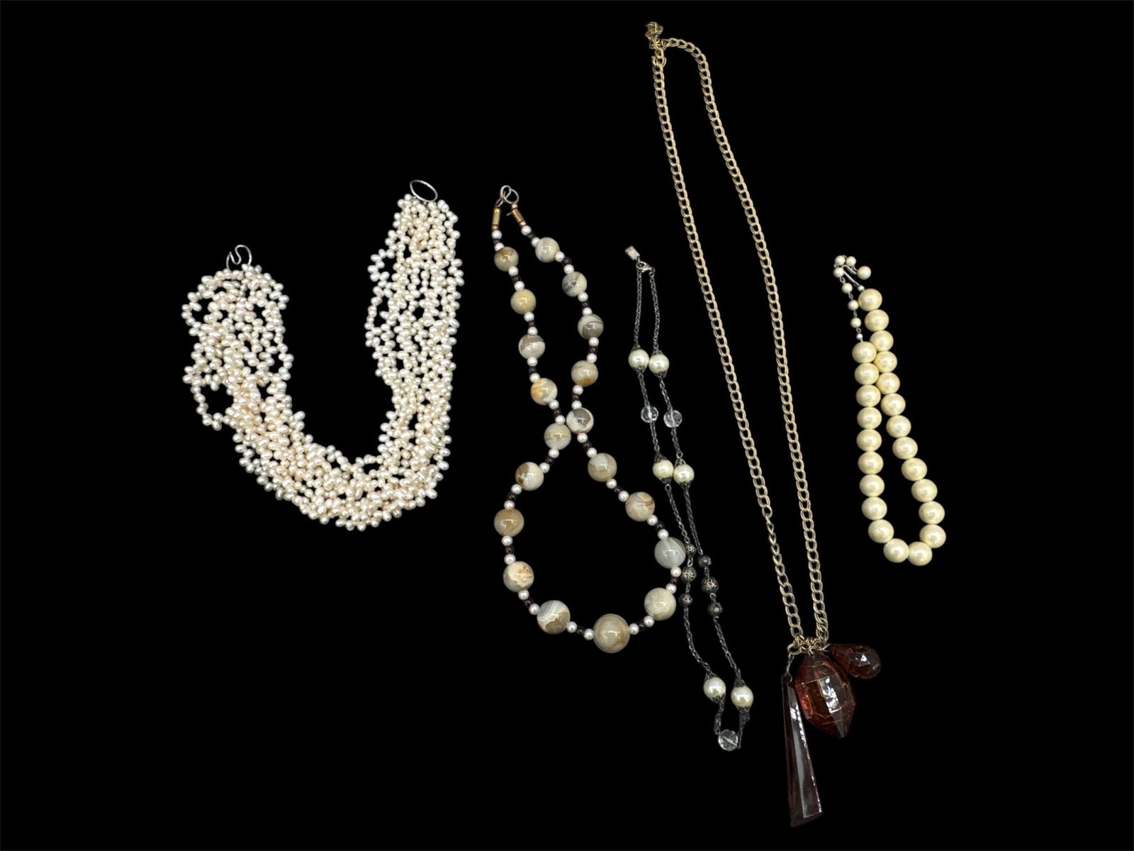 Assorted Costume Jewelry Necklaces: Group of assorted vintage costume jewelry necklaces including: • Multi-strand white beaded necklace• Faux pearl and bead necklace