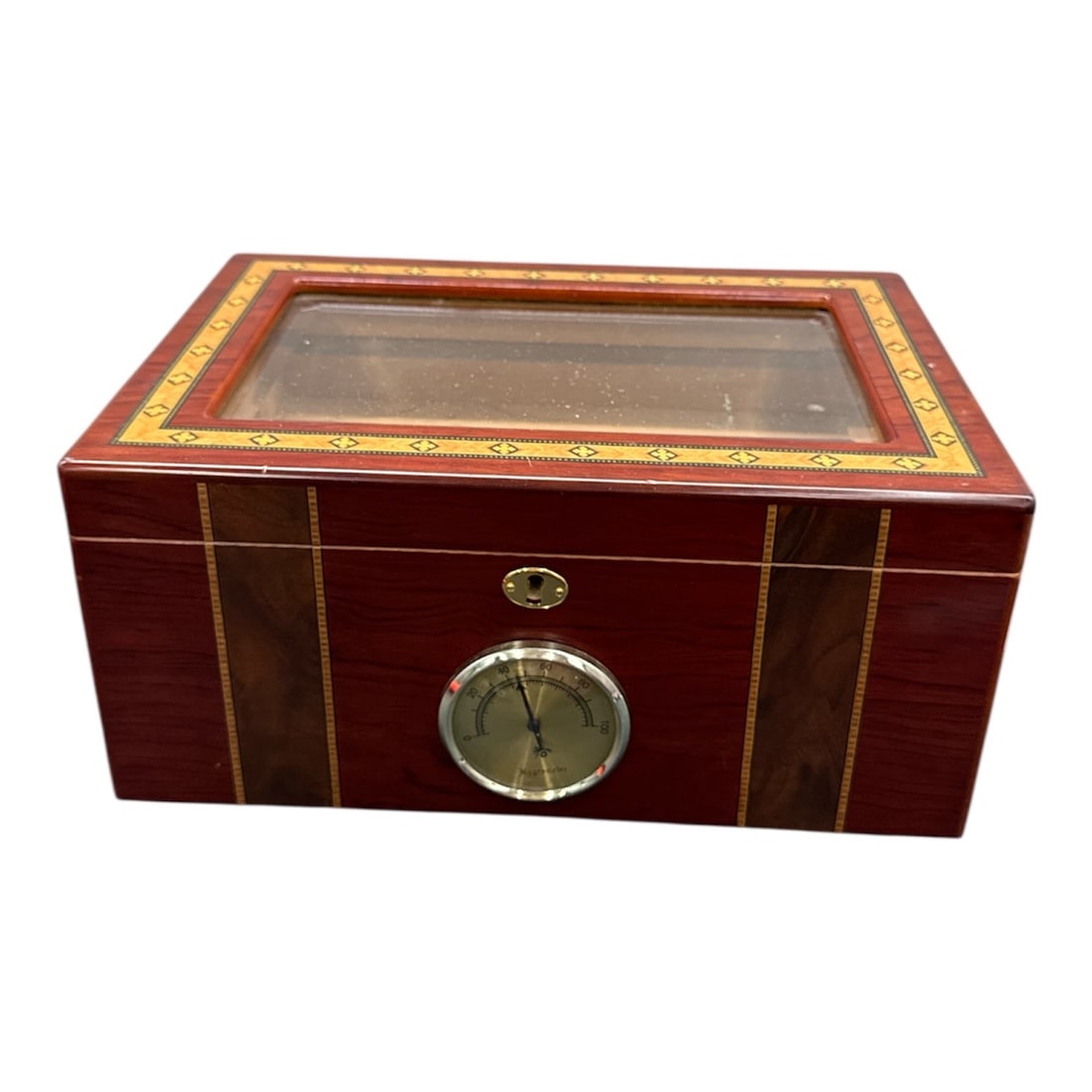 Cedar-Lined Wood Cigar Humidor with Glass Lid and Hygrometer: Classic tabletop cigar humidor featuring a polished wood veneer exterior and a hinged glass viewing lid. The interior is cedar-lined with slotted airflow channels, designed to help maintain proper