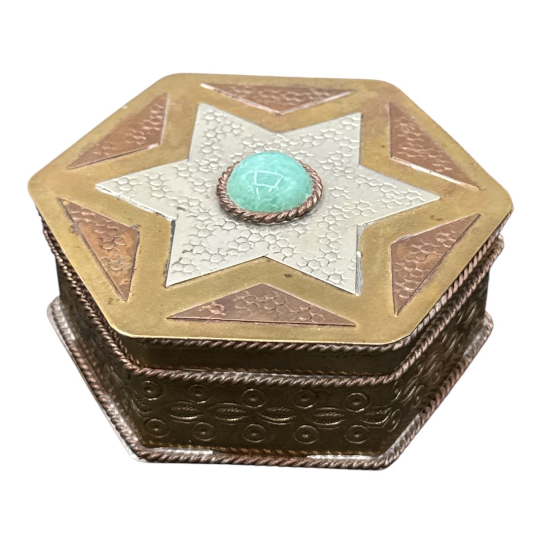 Vintage Hexagonal Inlaid Trinket Box: Item OverviewForm: Hexagonal (six-sided) lidded keepsake or jewelry box.Style: Exhibits influences of Middle Eastern or North African (Egyptian/Ottoman) metalwork and