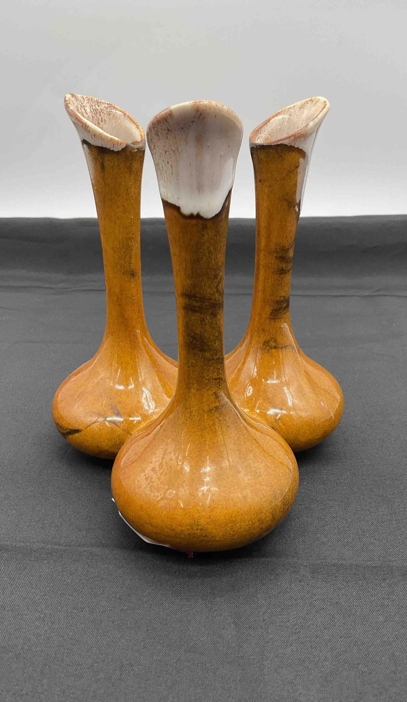Vintage Van Briggle Pottery Triple Bud Vase: Trio of tall, narrow-necked vases with organic flared openings in golden glaze. Each piece is marked on the base with the Van Briggle hallmark and numbering. Medium: Glazed ceramic