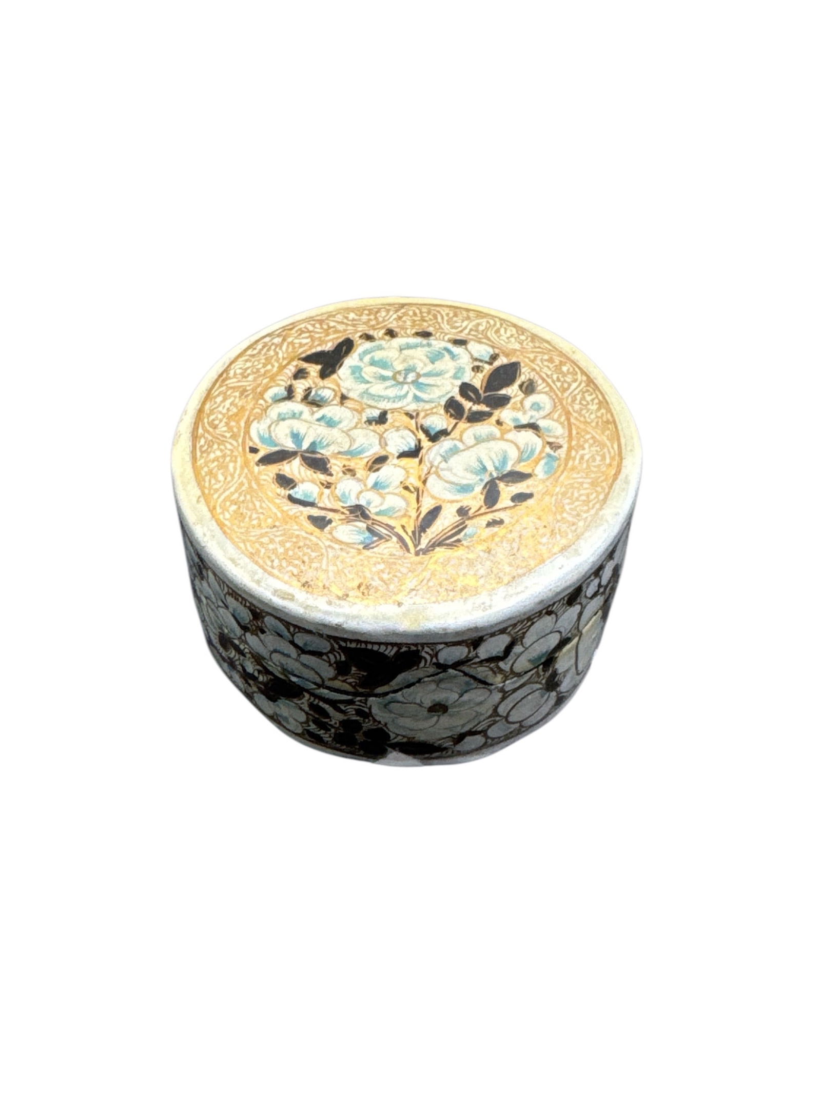 Decorative Gilt and Enamel Floral Trinket Box: This lot features a small decorative trinket box with a gilt-toned lid adorned with an enameled floral design in soft blue and white tones. The sides are finished in a contrasting dark ground with