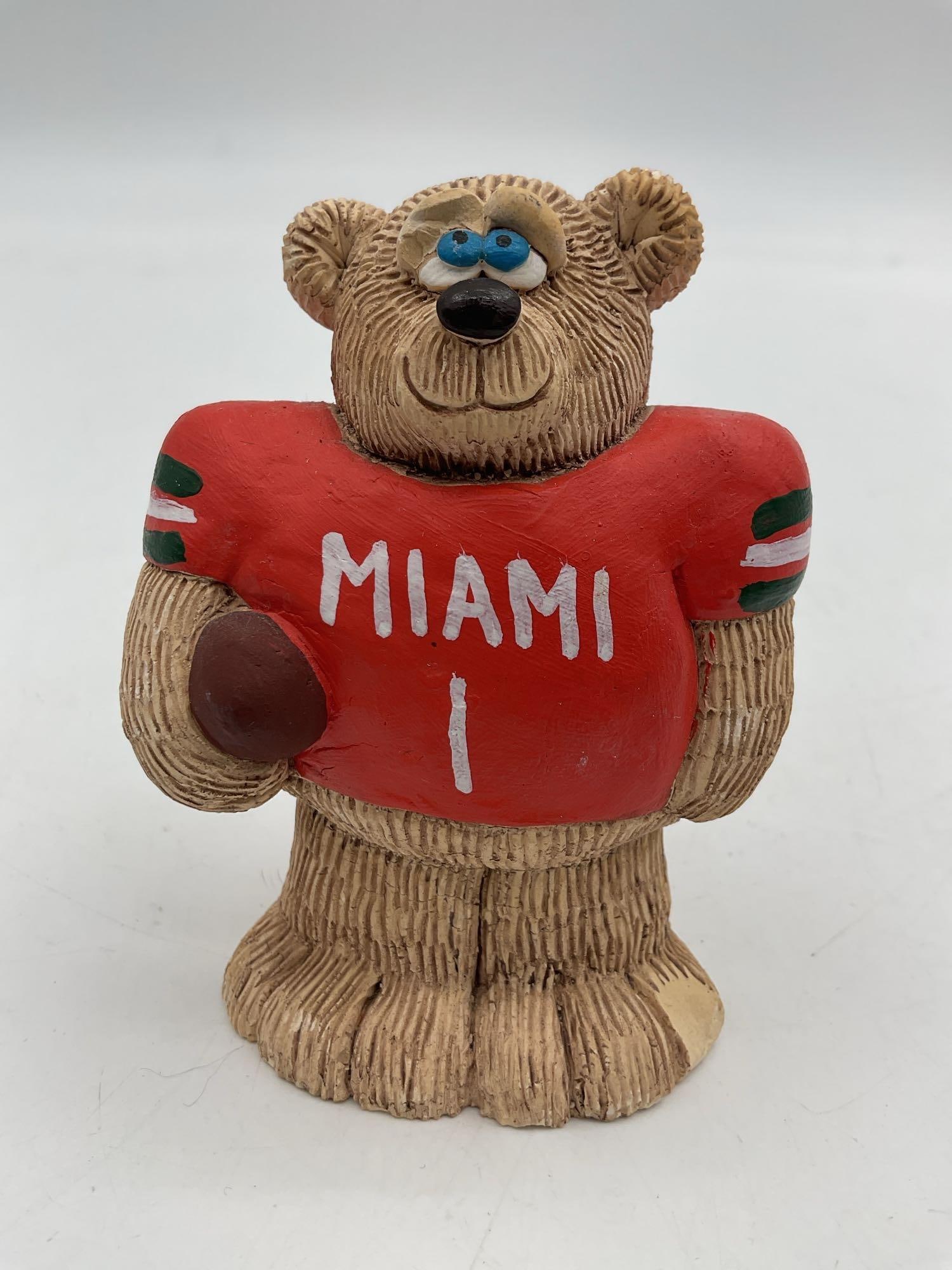 University of Miami Hurricanes Football Bear Figurine:  This collectible figurine features a bear dressed in a University of Miami Hurricanes football jersey, holding a football. The design is playful and detailed, making it a great decorative item