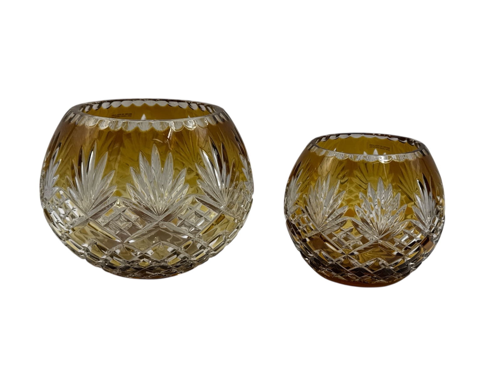 Pair of Amber Cut Glass Bowls with Starburst Pattern: Elegant pair of amber cut glass bowls featuring richly faceted starburst and diamond lattice patterns throughout. The warm golden tone enhances the brilliance of the deep cuts, creating beautiful