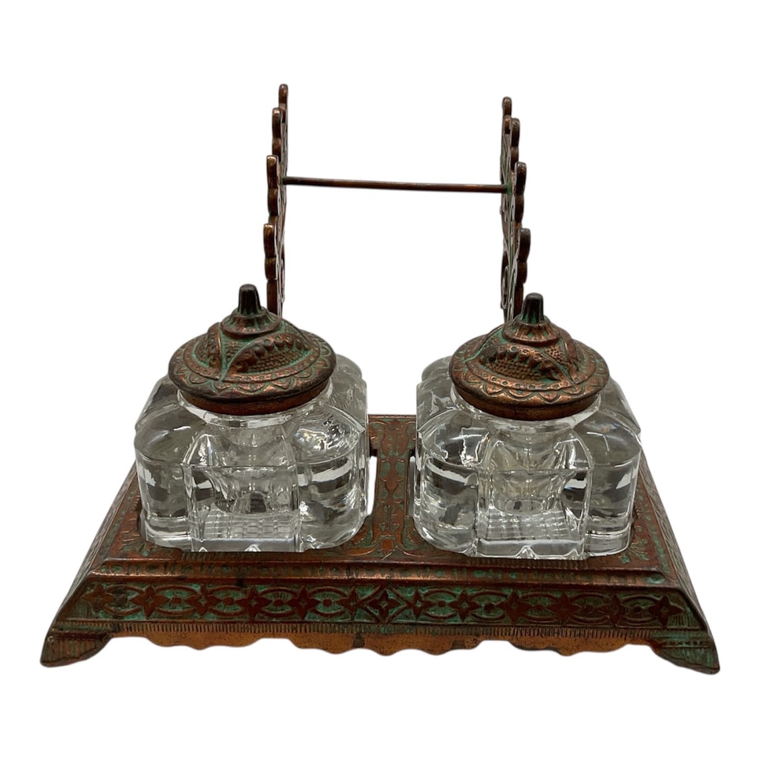 Antique Double Inkwell Desk Set with Ornate Metal Stand: Antique desk inkwell set featuring two square cut glass ink bottles fitted with decorative metal lids, mounted on an ornate metal tray base. The stand includes a central handle supported by decorative