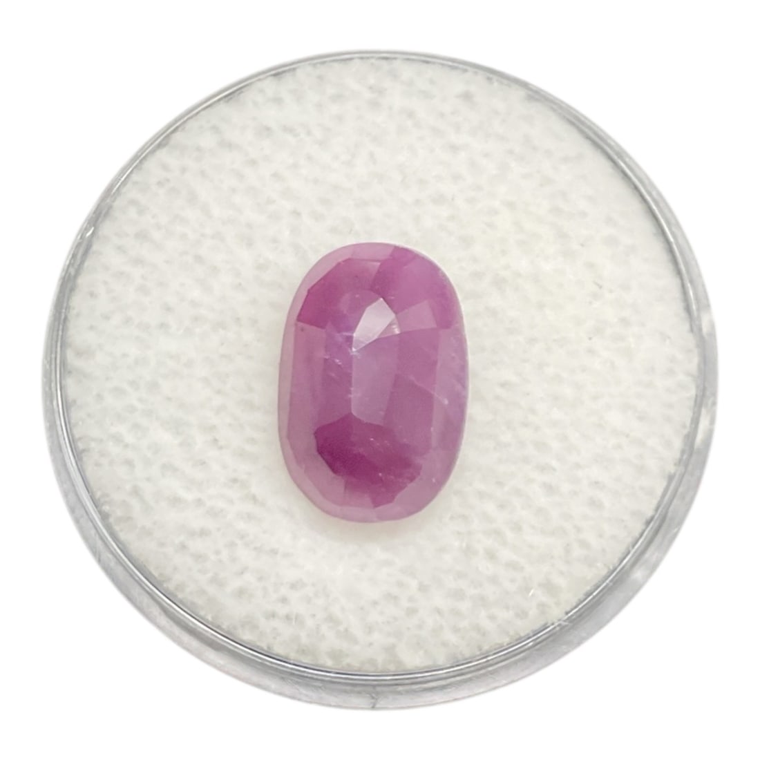Natural Ruby Loose Gemstone 5.33 Carats Oval Cut: This loose natural ruby gemstone weighs 5.33 carats and features an elongated oval cut with a vibrant pinkish-red hue. The stone displays attractive transparency with visible internal characteristics
