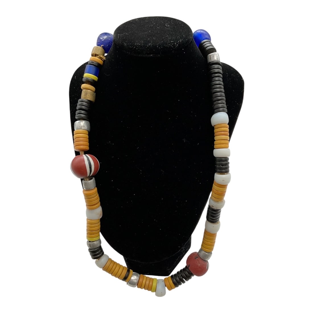 Authentic African Beaded Necklace: A vibrant and culturally rich African beaded necklace featuring an assortment of multicolored trade beads in varying shapes and sizes. The necklace is composed of stacked disc beads, rounded beads, an
