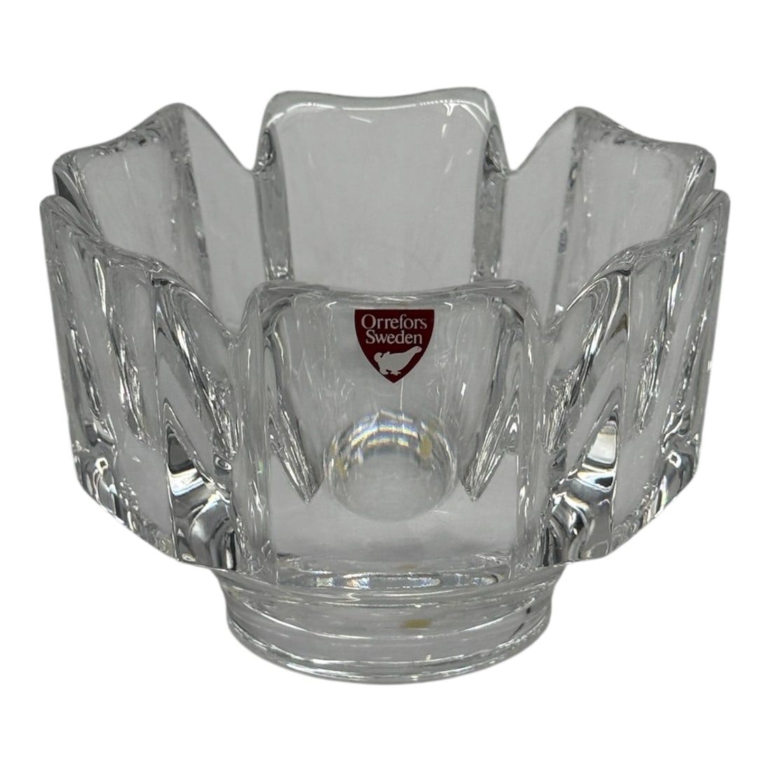 Orrefors Sweden Crystal Votive Candle Holder: A clear crystal votive candle holder produced by Orrefors, Sweden, known for its high-quality Scandinavian glass design. The piece features a sculptural form with vertical faceted panels that create s