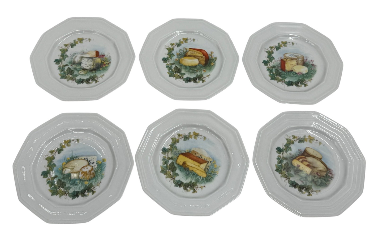 Six Medici Compagnie Nationale de Porcelaine France Porcelain Plates: A set of six porcelain plates produced by Medici for Compagnie Nationale de Porcelaine, France. Each plate features an octagonal form with a central decorative reserve depicting assorted food motifs s