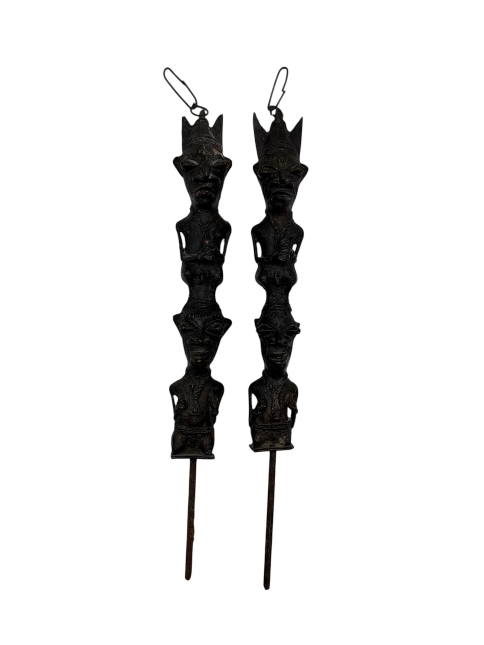 African Pair of Yoruba Brass Ogboni Edan Figures: This lot features a matched pair of Edan figures, traditional ceremonial insignia of the Ogboni society among the Yoruba people of Nigeria. Cast in solid brass, these figures represent the male and fe