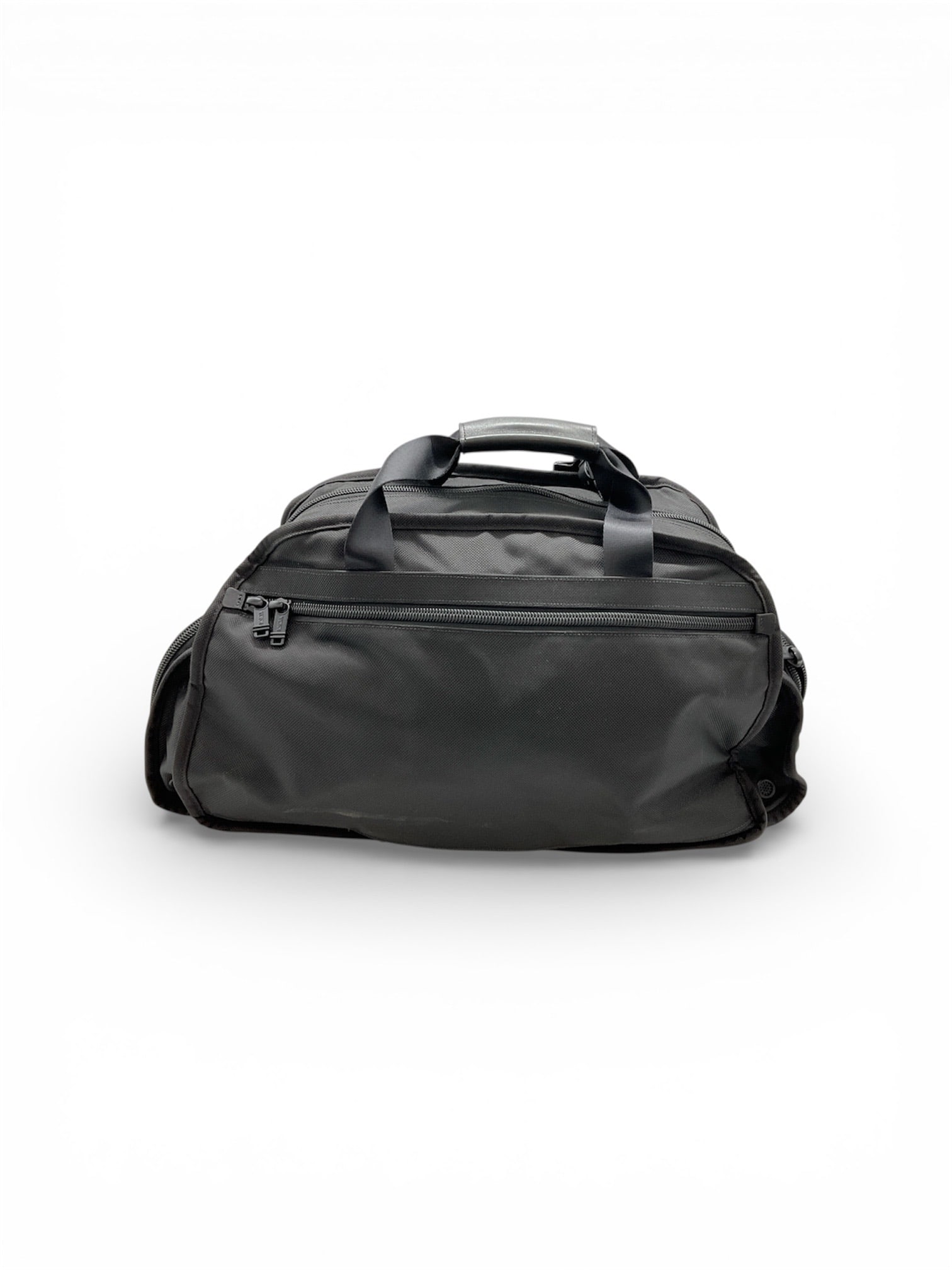 Tumi Alpha Series Large Travel Duffel: This robust travel piece is a classic Tumi Alpha series large duffel, engineered for durability and high-capacity travel. Crafted from Tumi's signature