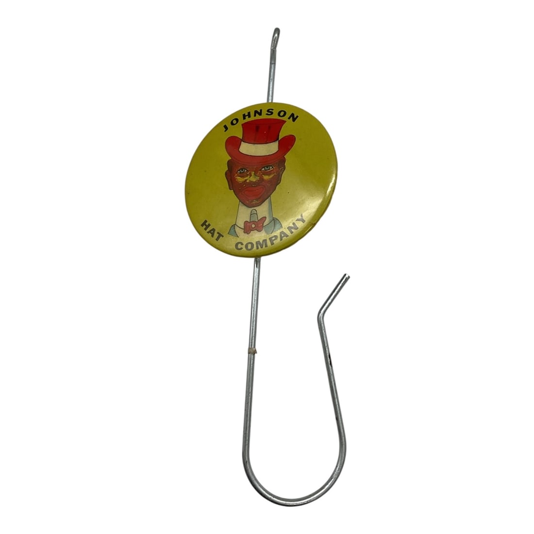 Johnson Wax Company Advertising Receipt Hook, Mid-20th Century: A vintage advertising receipt hook featuring a round tin lithograph badge for Johnson Wax Company, mounted on a metal hook form. The badge displays the company name and logo in bold colors with a styl