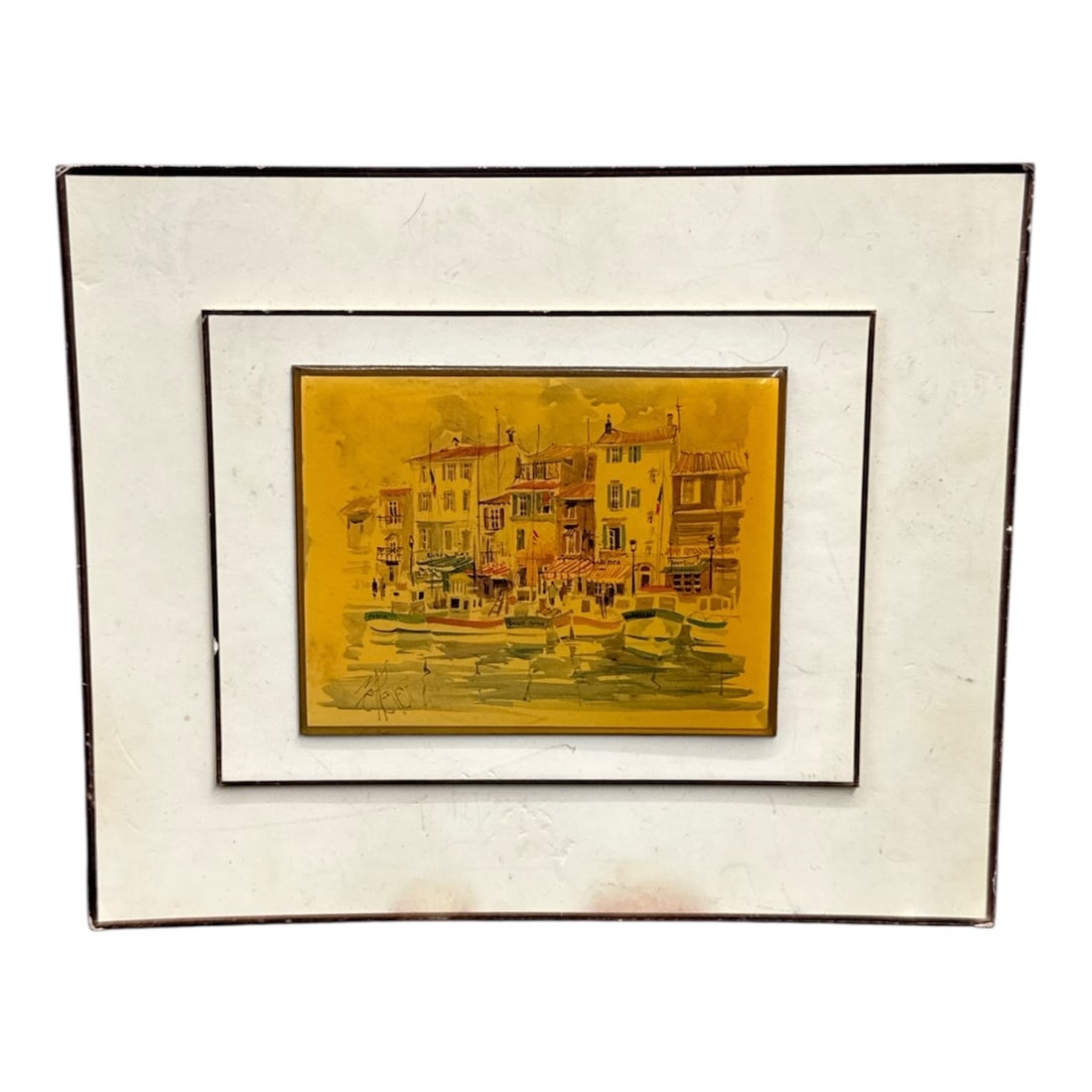 Venice from 1973, Signed, Artist Unknown: Decorative framed print depicting a charming coastal harbor village with boats docked along the waterfront. Rendered in warm yellow and golden tones with fine architectural detailing, the scene captur
