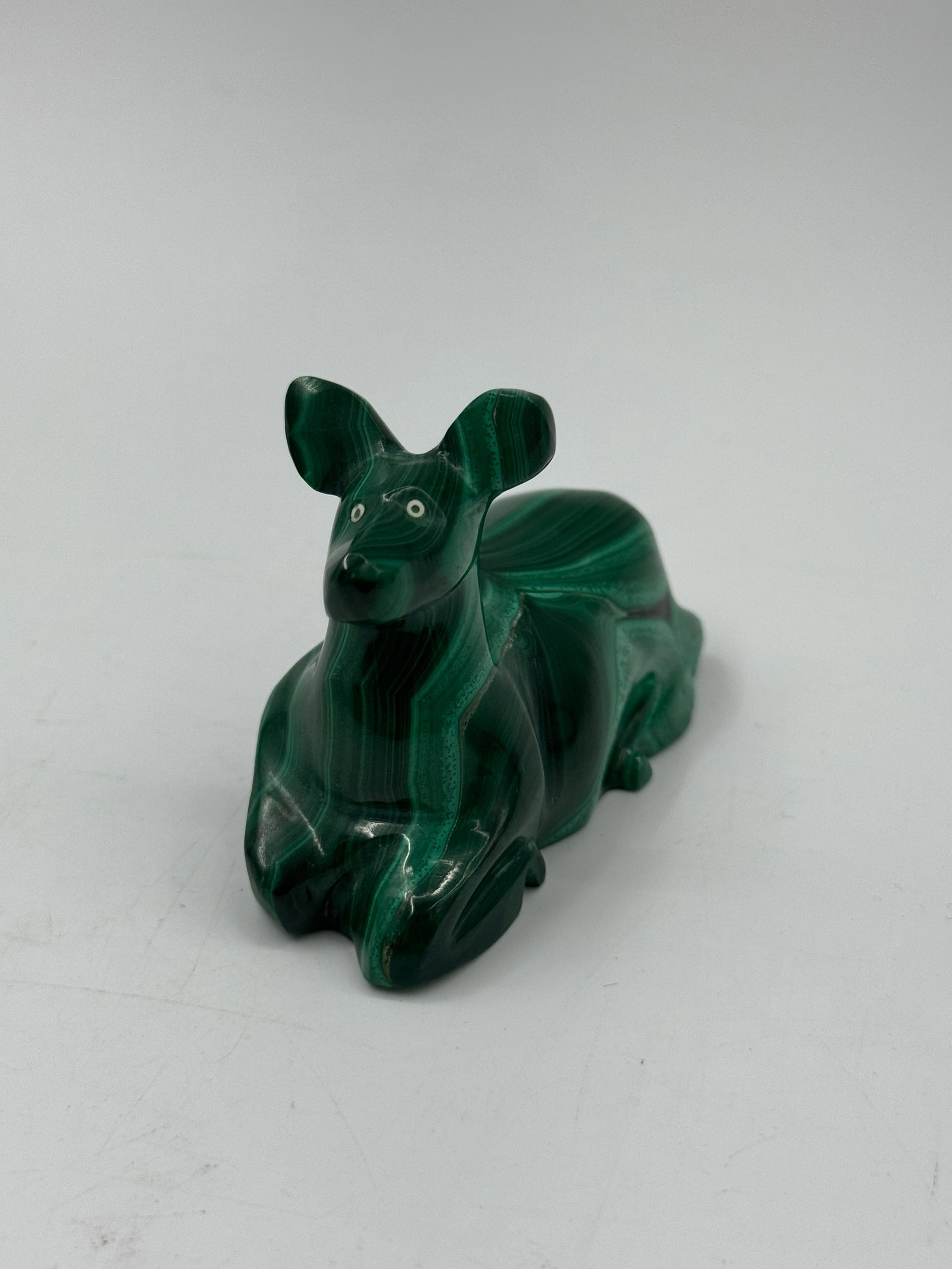 Malachite Carved Animal Figurine: A carved animal figurine made of malachite. The piece features the characteristic banding of malachite. Dimensions approximately 3 x 2 x 1 inches.