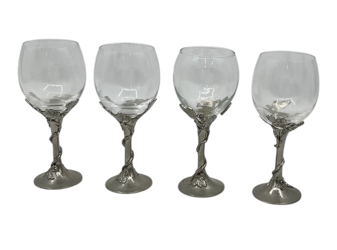 Set of Four RCR Crystal Wine Glasses with Pewter Stems: Set of four RCR crystal wine glasses featuring clear bowls mounted on ornate pewter stems with sculptural figural detailing. The stems display intricate designs, adding a decorative and distinctive el