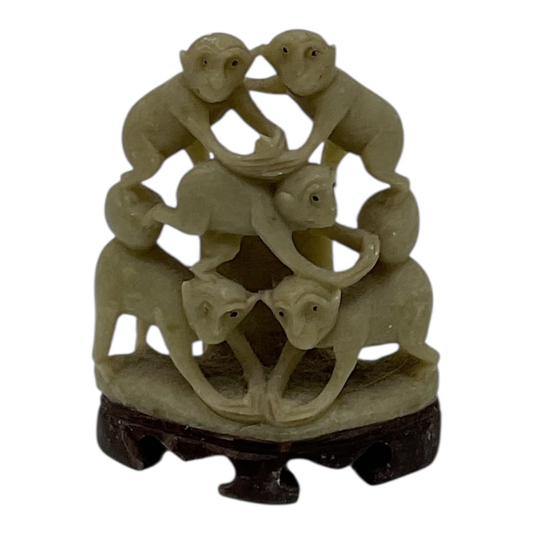 Carved Stone Monkeys Group Sculpture on Stand: Finely carved stone sculpture depicting a group of monkeys arranged in a circular, interconnected formation. The composition features multiple monkeys climbing and interacting, creating a dynamic and