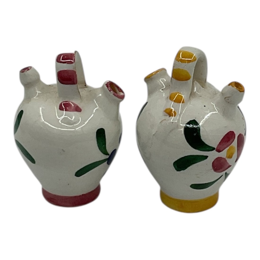 Pair of Miniature Italian Style Ceramic Multi-Spout Vessels: Charming pair of miniature ceramic vessels in the Italian style, each featuring multiple spouts and a loop handle. Decorated with hand-painted floral motifs in vibrant colors, these pieces reflect tra