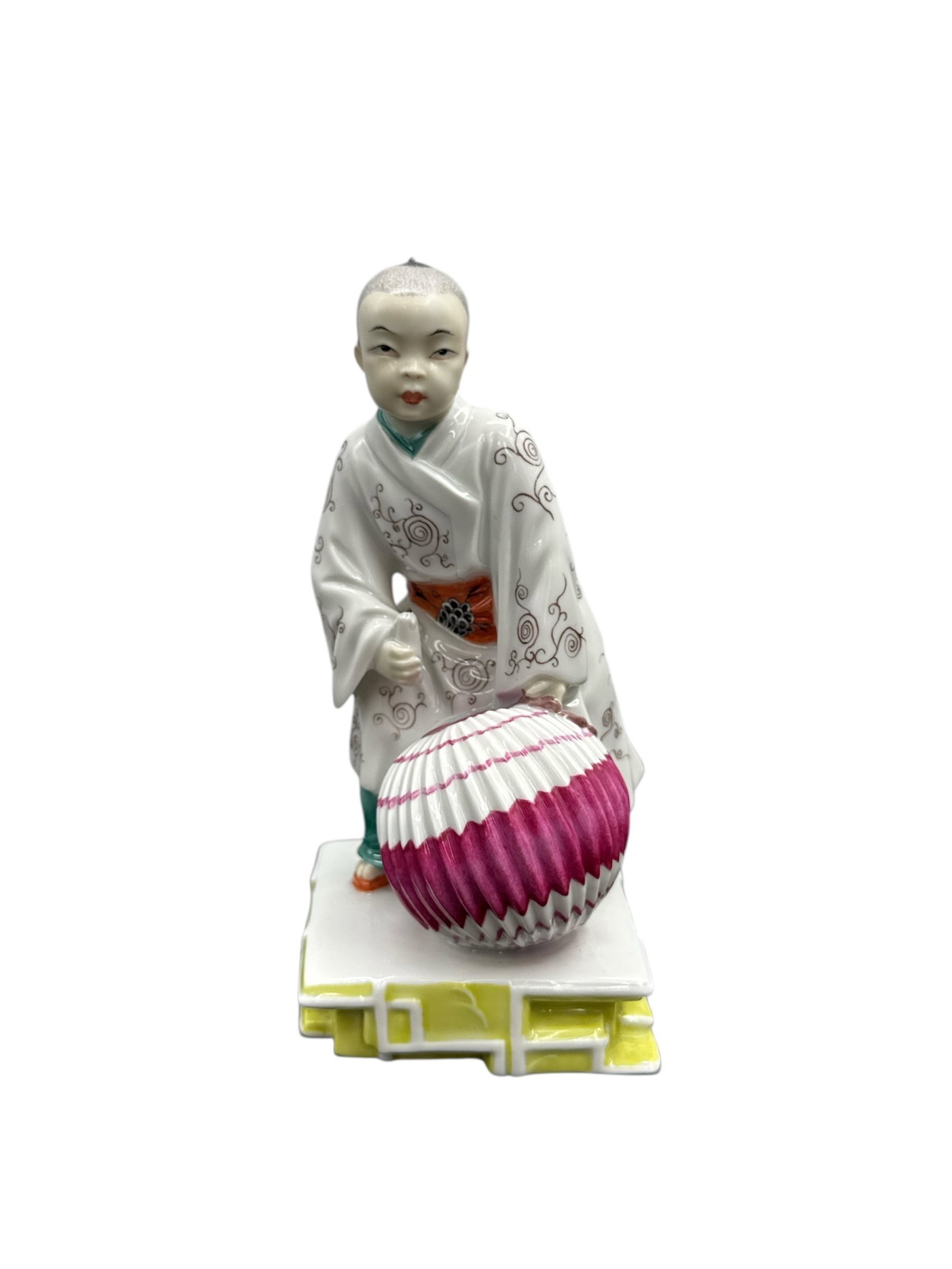 AUGARTEN WIEN AUSTRIA CERAMIC JAPANESE BOY WITH A BALL- 16910: Decorative porcelain figure depicting an Asian boy dressed in traditional attire and holding a lantern. The figure is finely modeled with expressive facial features and hand-painted details, including