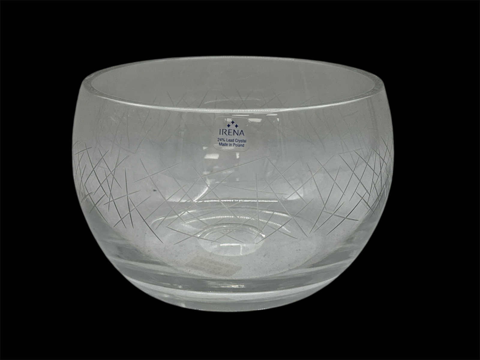 Cut Glass Round Serving Bowl: A clear cut glass serving bowl featuring a rounded form with etched-style crosshatch and geometric detailing around the body. The smooth rim and thick base provide stability, while the subtle faceting