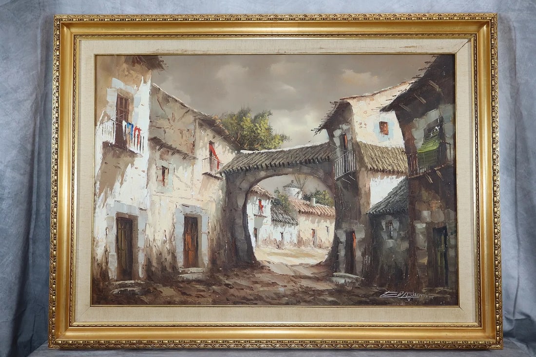 Village Scene signed, Artist Unknown: This painting portrays a tranquil village scene, highlighting cobblestone streets, traditional houses, and an arched passage that leads the viewer's eye deeper into the composition. The color pale