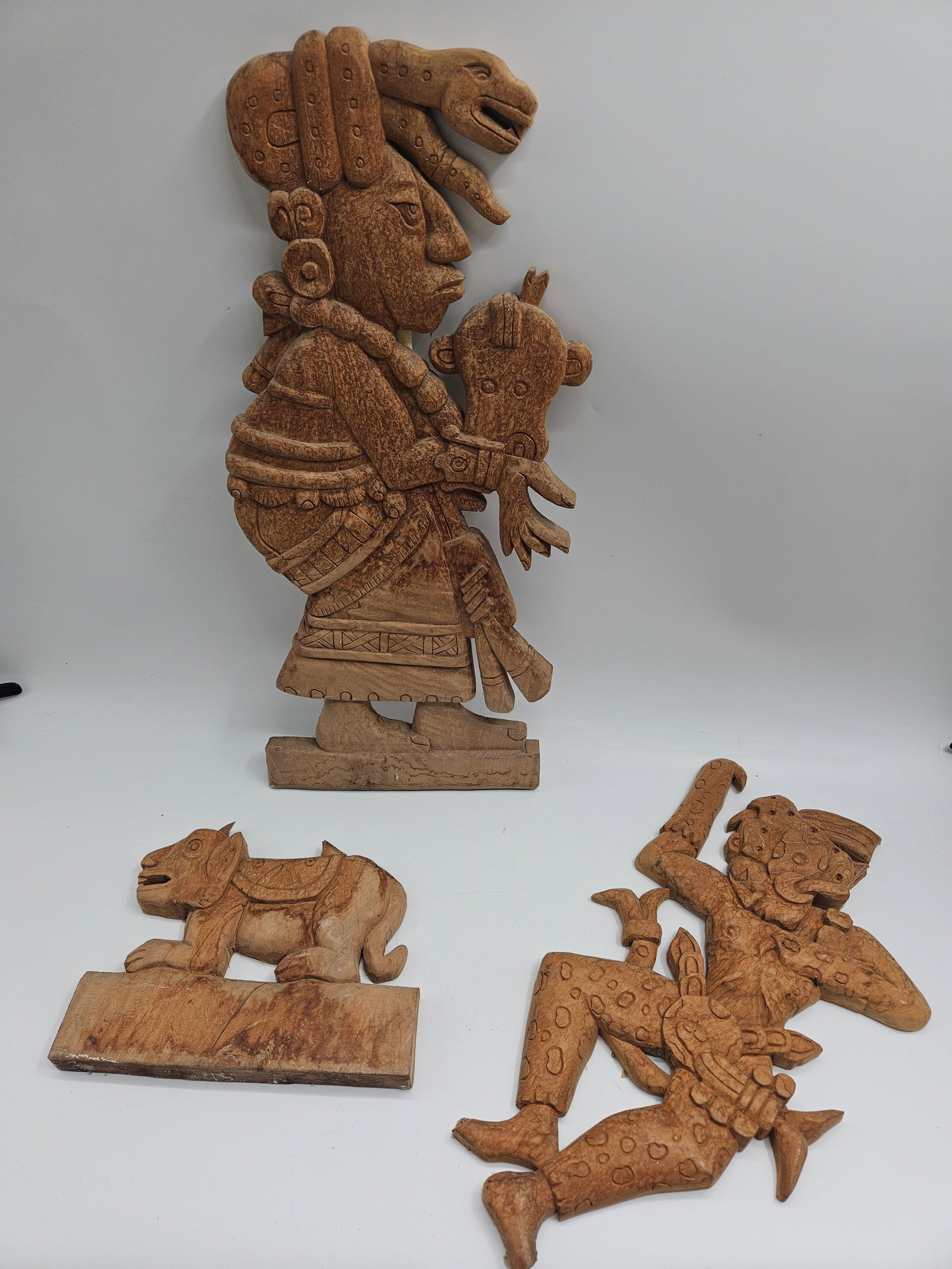 Set of Three Hand-Carved Wooden Figures: Group of three intricately hand-carved wooden figures depicting traditional Indian characters and animals. Each piece showcases detailed craftsmanship and cultural motifs, with natural wood patina.