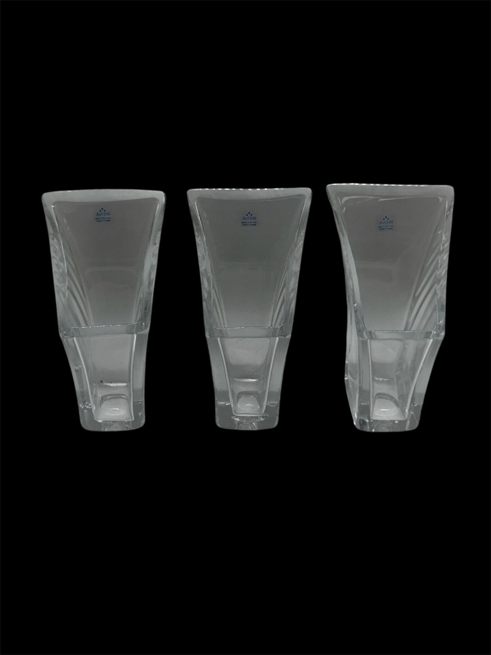 Set of Three Modern Clear Art Glass Vases: A set of three modern clear art glass vases featuring an angular, asymmetrical form with sculptural lines and thick bases. Each vase displays molded geometric detailing that enhances light reflection