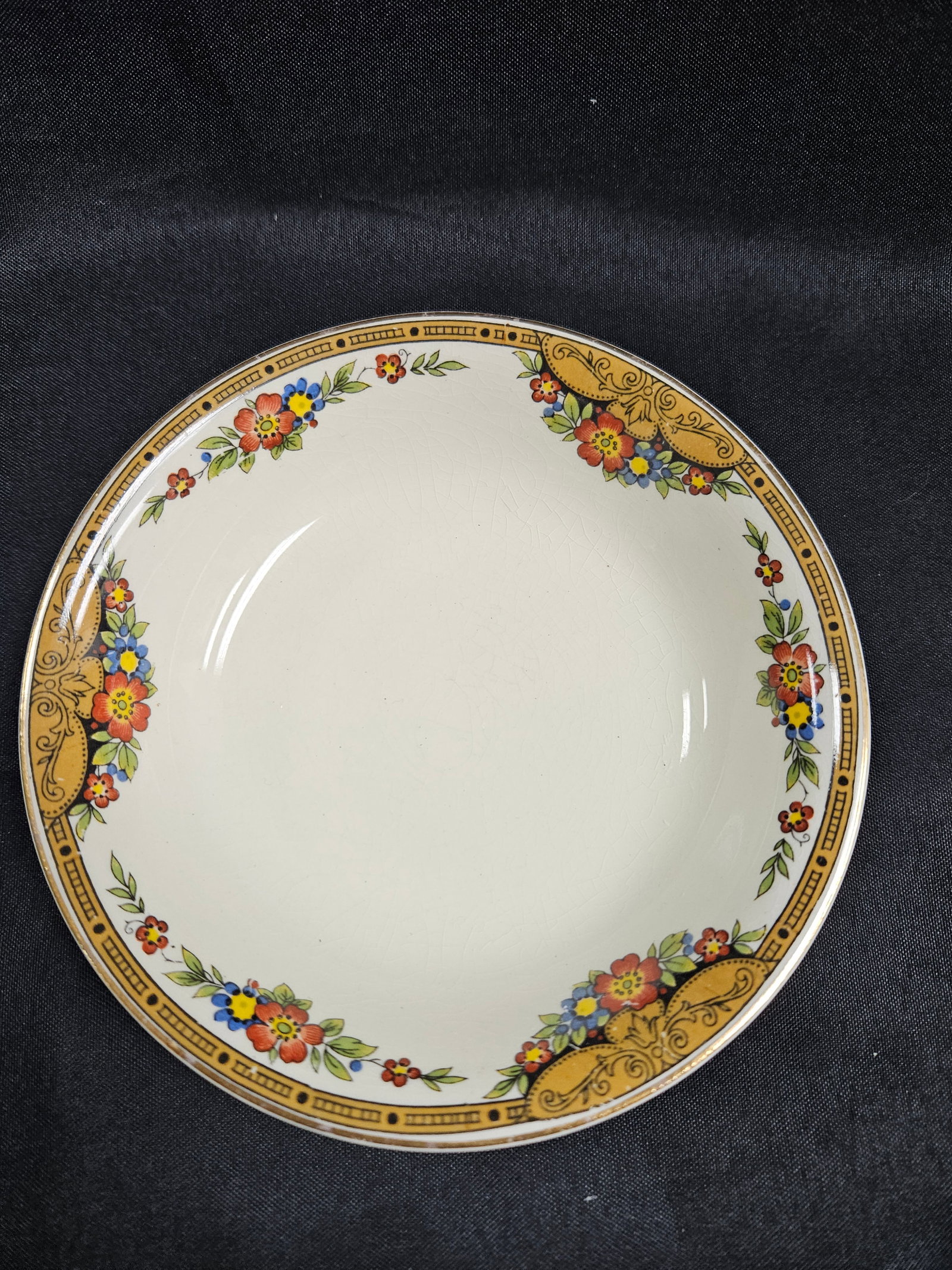 J & G Meakin 'Sunshine' Bowl, England: Vintage J & G Meakin 'Sunshine' Sol 381415 England bowl. Features a white base with a decorative floral and geometric border in orange, yellow, and blue. Marked on the bottom. Measures app
