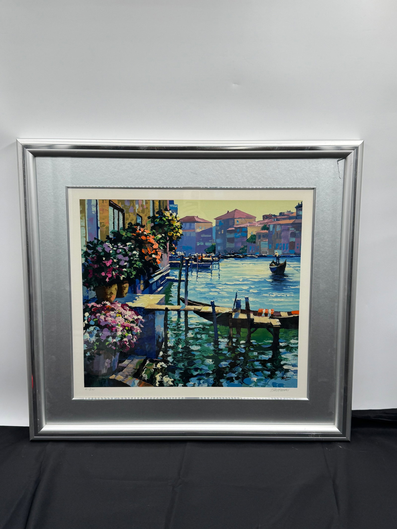 Venice Suite by the American artist Howard Behrens (1933-2014) w/ COA: Framed print by T. Bearens depicting a Venetian canal scene with flowers. Signed lower right. Numbered XCI/CXV lower left. Image size approximately 19.5 x 19.5 inches. Frame measures 31 x 28.5 inches.
