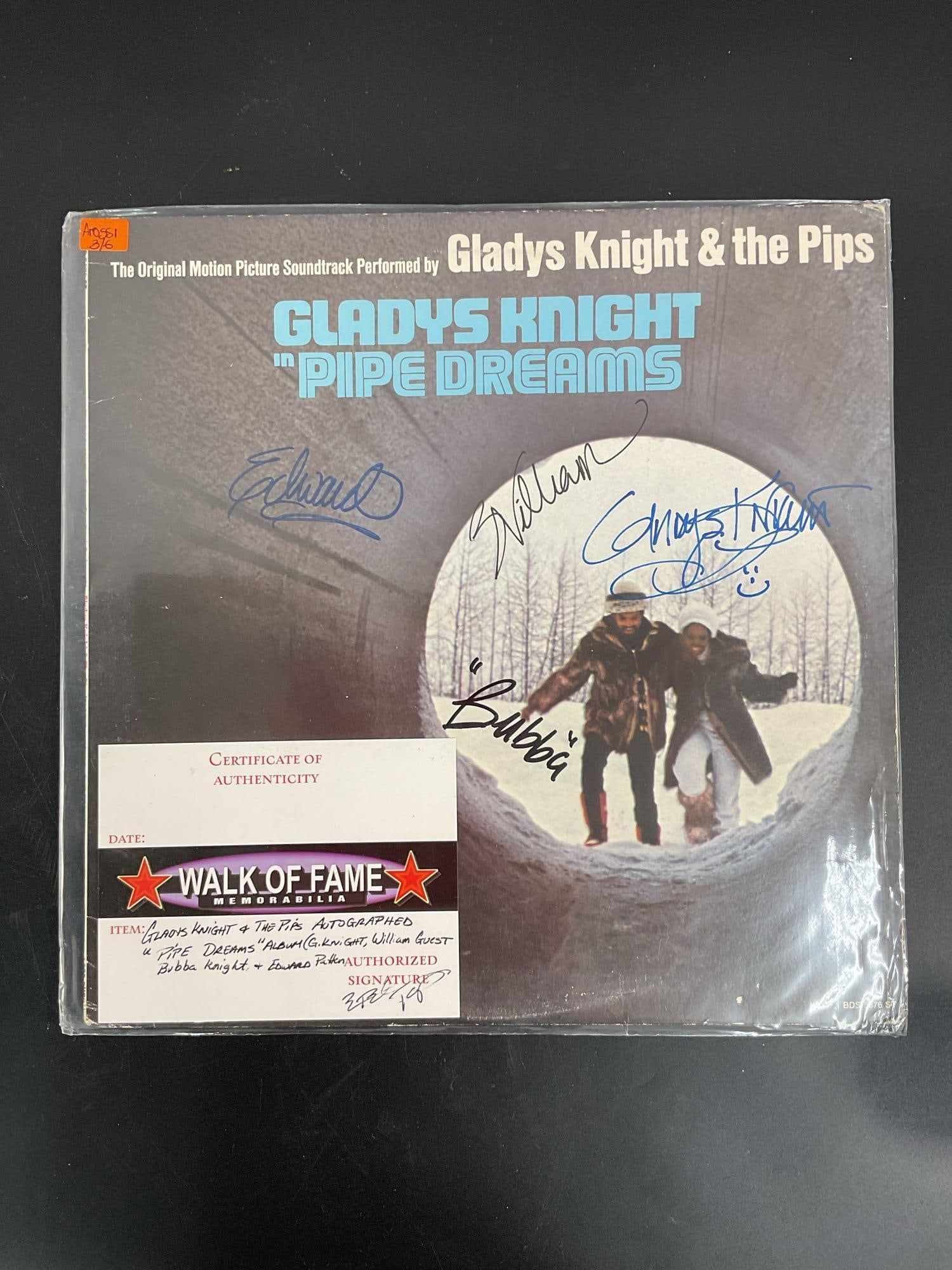 "Pipe Dreams" by Gladys Knight & The Pips Autographed Vinyl Record: This vinyl record features the "Pipe Dreams" soundtrack by Gladys Knight & The Pips, signed by the band members. The cover art showcases a reflective and stylish image of the group, and