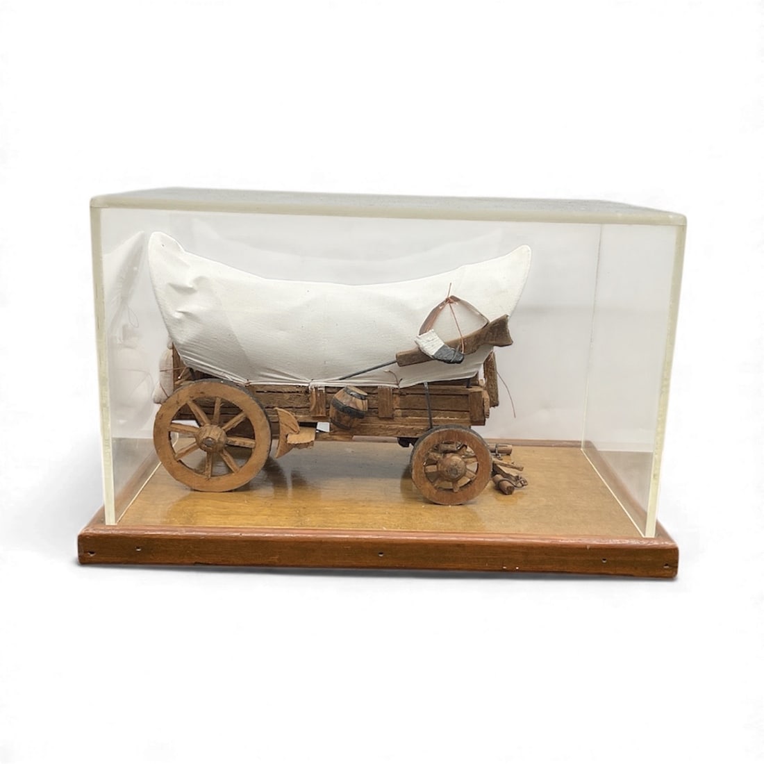 Covered Wagon Model Made in Mexico: Handcrafted wooden model of a classic covered wagon, featuring a canvas top and detailed wagon construction. Housed in a protective display case with a wooden base. Dimensions: H:9 in W: 14 in L: 8 in