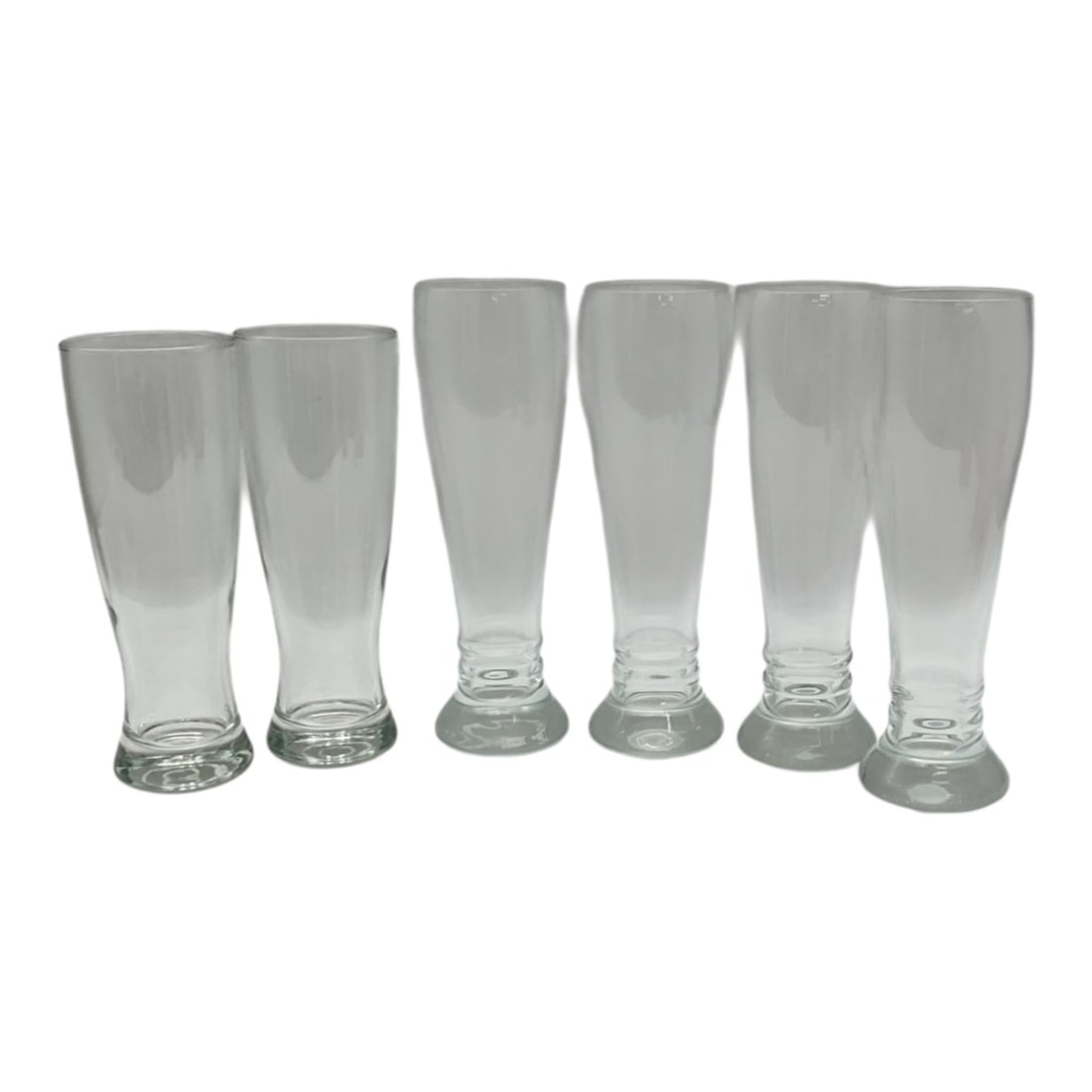 Set of Six Clear Beer and Pilsner Glasses in Two Sizes: This set of six clear beer glasses includes two different height styles, offering a versatile assortment for serving beer, pilsners, lagers, or specialty brews. With a clean tapered form and sturdy ba