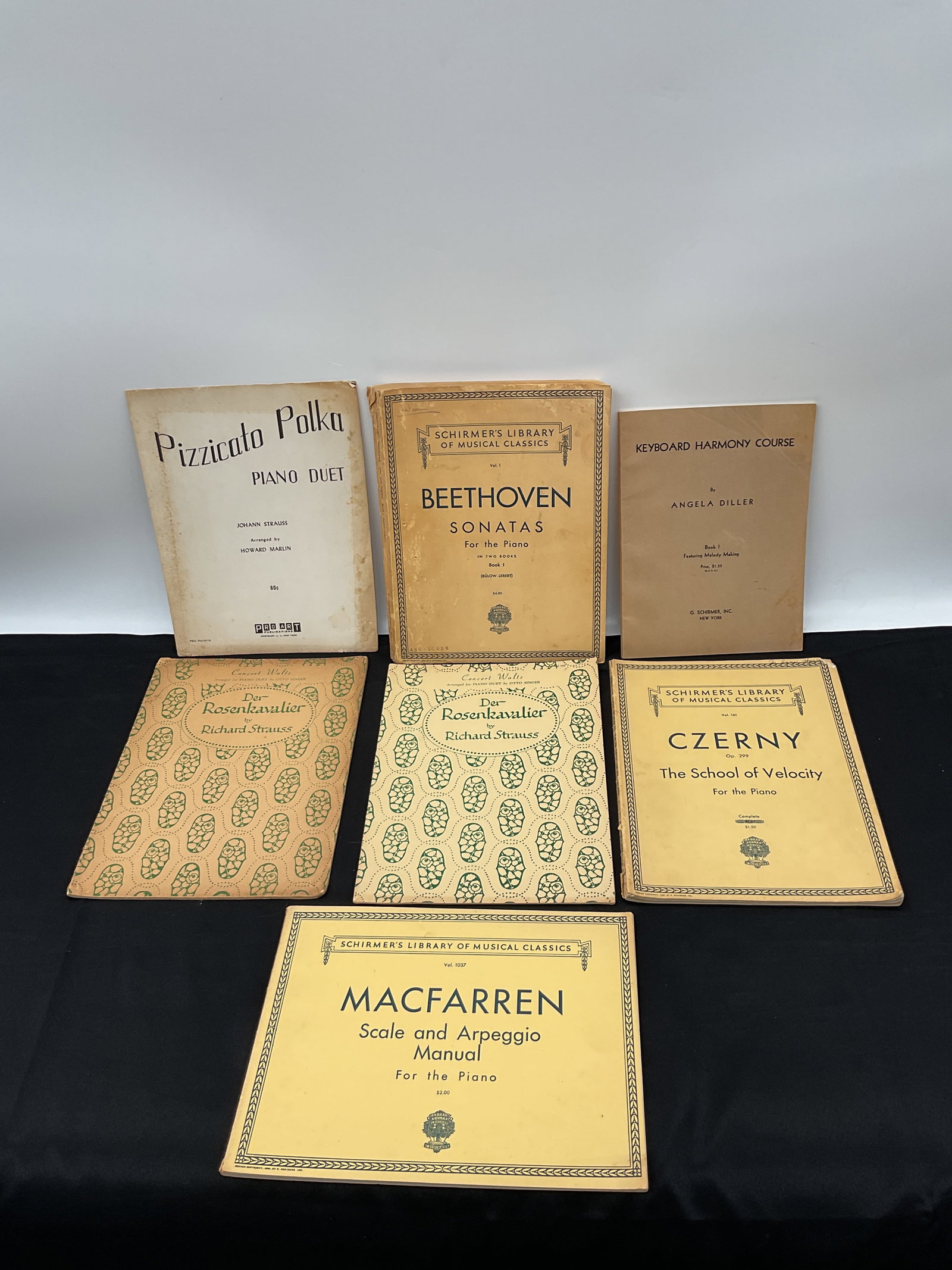 Collection of Vintage Piano Sheet Music: A collection of seven vintage piano sheet music books, including works by Beethoven, Czerny, Macfarren, and Strauss. Various publishers. Some wear consistent with age.
