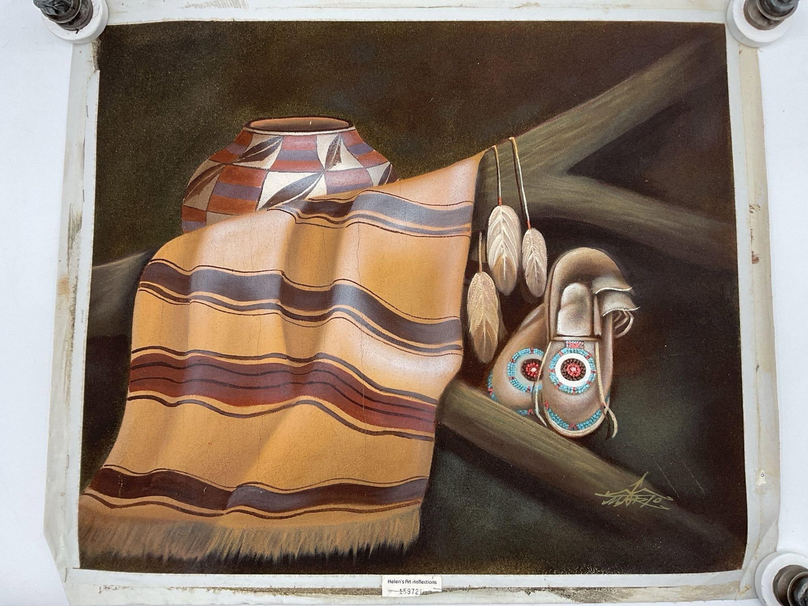 Native Still Life with Moccasins by Mario: A refined Southwestern still life featuring a patterned clay pot, striped woven blanket, feather ornaments, and beaded moccasins arranged on a wooden rail. The soft, airbrushed finish and earthy tones
