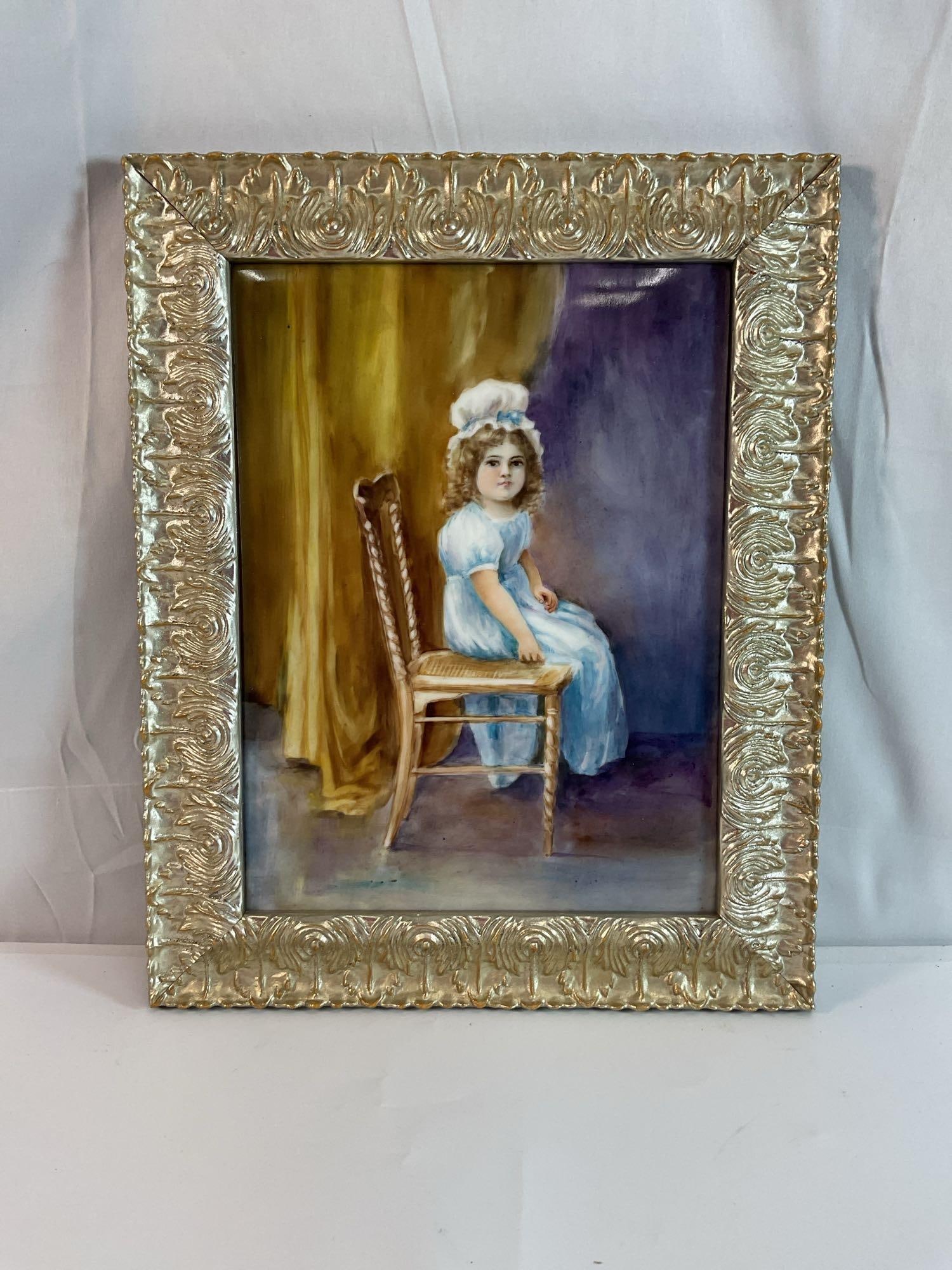 Antique Porcelain Painting: This is a hand-painted porcelain plaque depicting a young girl in a blue dress and bonnet, resting her arms on the back of a wooden chair. The background features rich golden hues blending into deep p