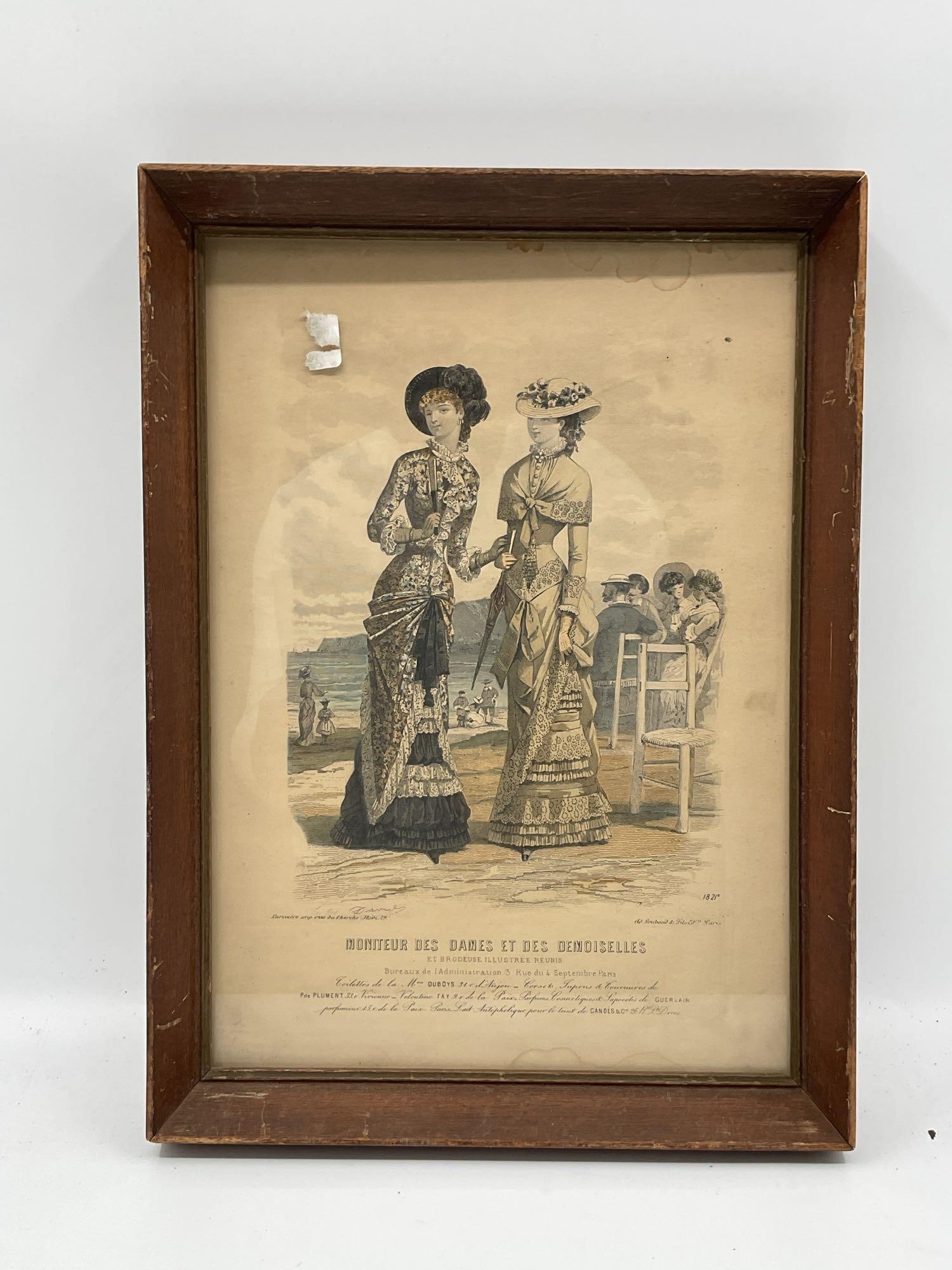 Moniteur des Dames et des Demoiselles Antique French Engraving: Elegant hand-colored fashion plate from the 1877 issue of Moniteur des Dames et des Demoiselles, a Parisian fashion magazine. Depicts two well-dressed women in elaborately detailed seaside walking dre