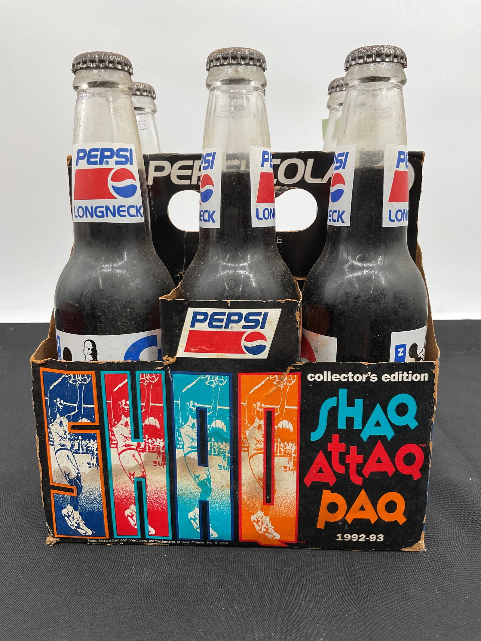 Shaq Attaq Paq Pepsi Bottles - Collector's Edition Six Pack: Collector's Edition "Shaq Attaq Paq" six-pack of 12 oz Pepsi bottles. Features Shaquille O'Neal and the Orlando Magic. Bottles appear unopened. 1992-93 season.