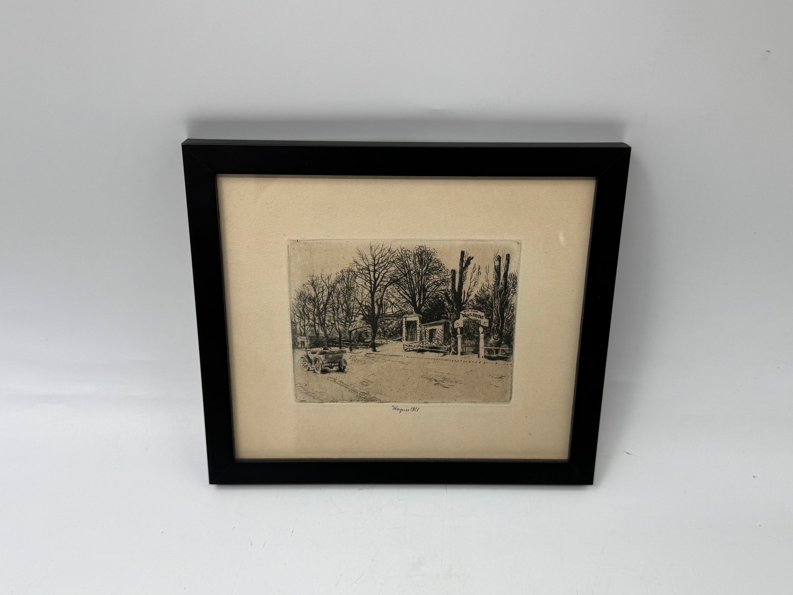 Otis Wagner, 1921, Etching of Park Scene: Etching on paper, signed 'Wagner 1921' in the plate. Depicts a park scene with trees and architectural elements. Framed in a black frame. Image size approximately 9 x 8 inches.
