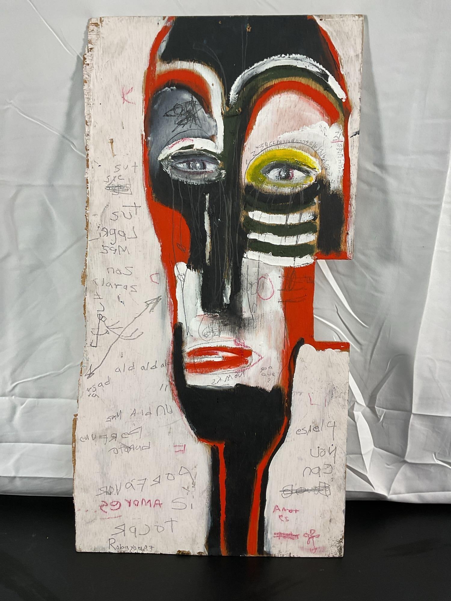 "Mucho Suerte" by Luis Robayo(Colombian/American) Oil on Board: This striking artwork features a bold and abstract face with a tribal or mask-like appearance. The composition is dominated by black, red, white, and yellow tones, with expressive brushstrokes and raw