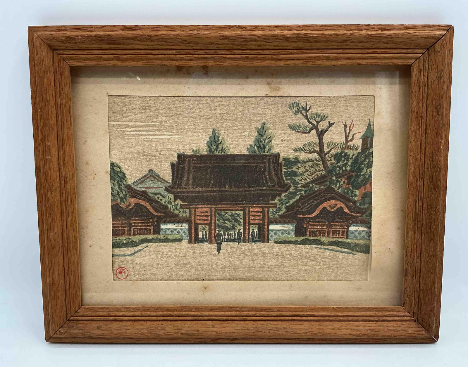 "Red Gate at the Imperial University" by Masao Maeda Japanese Woodblock: Vertical print depicting a traditional Asian temple complex with ornate architecture and detailed surrounding landscape. Includes calligraphic script along the side and a red artist seal mark. Framed