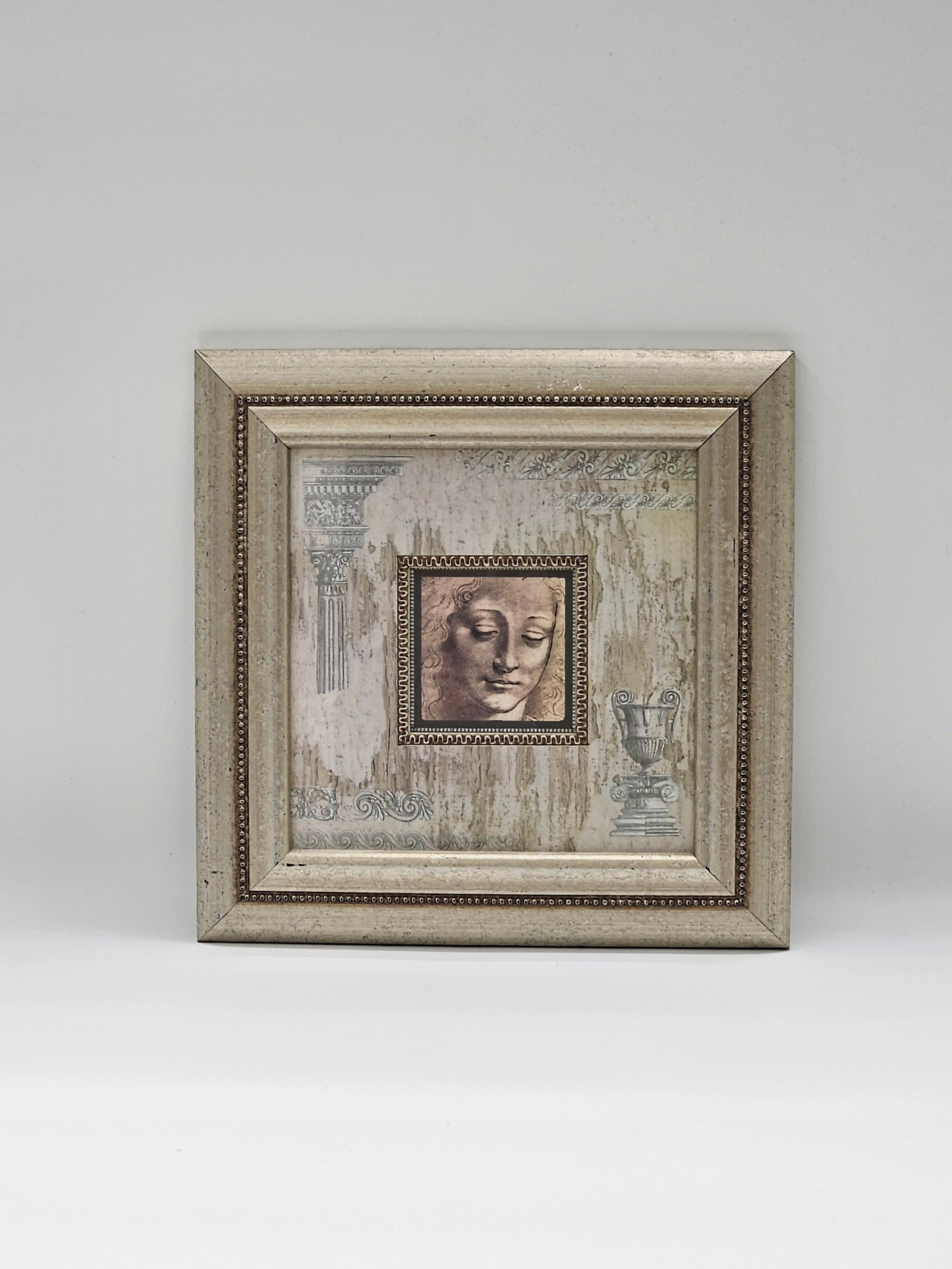 Tranquil Reflection — Framed Mixed Media Leonardo Davinci Print: Description: A beautifully framed art print depicting a serene, classical face — often interpreted as representing calm and introspection. The