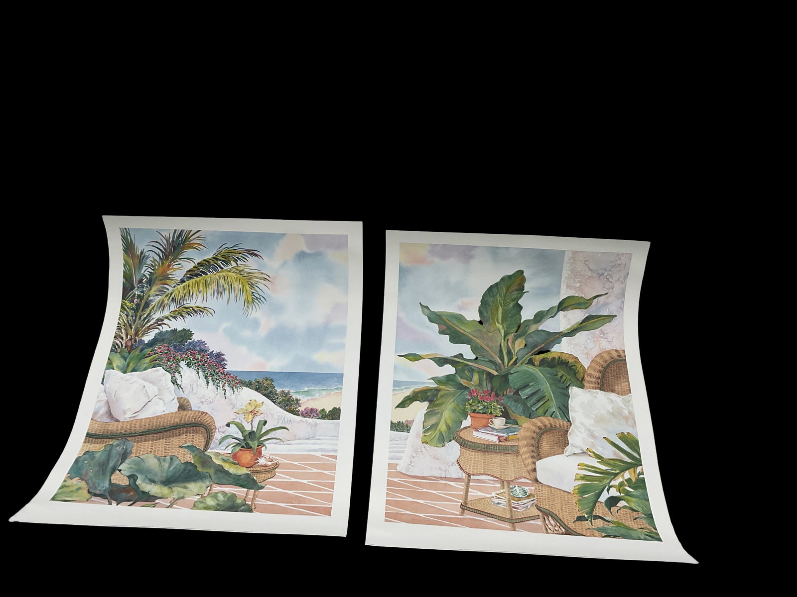 China Kwok – Coastal Interior Poster Set (2): Pair of serene posters by China Kwok featuring tropical coastal scenes with wicker furniture, lush plants, and ocean views. Sold together as a coordinated decorative set.