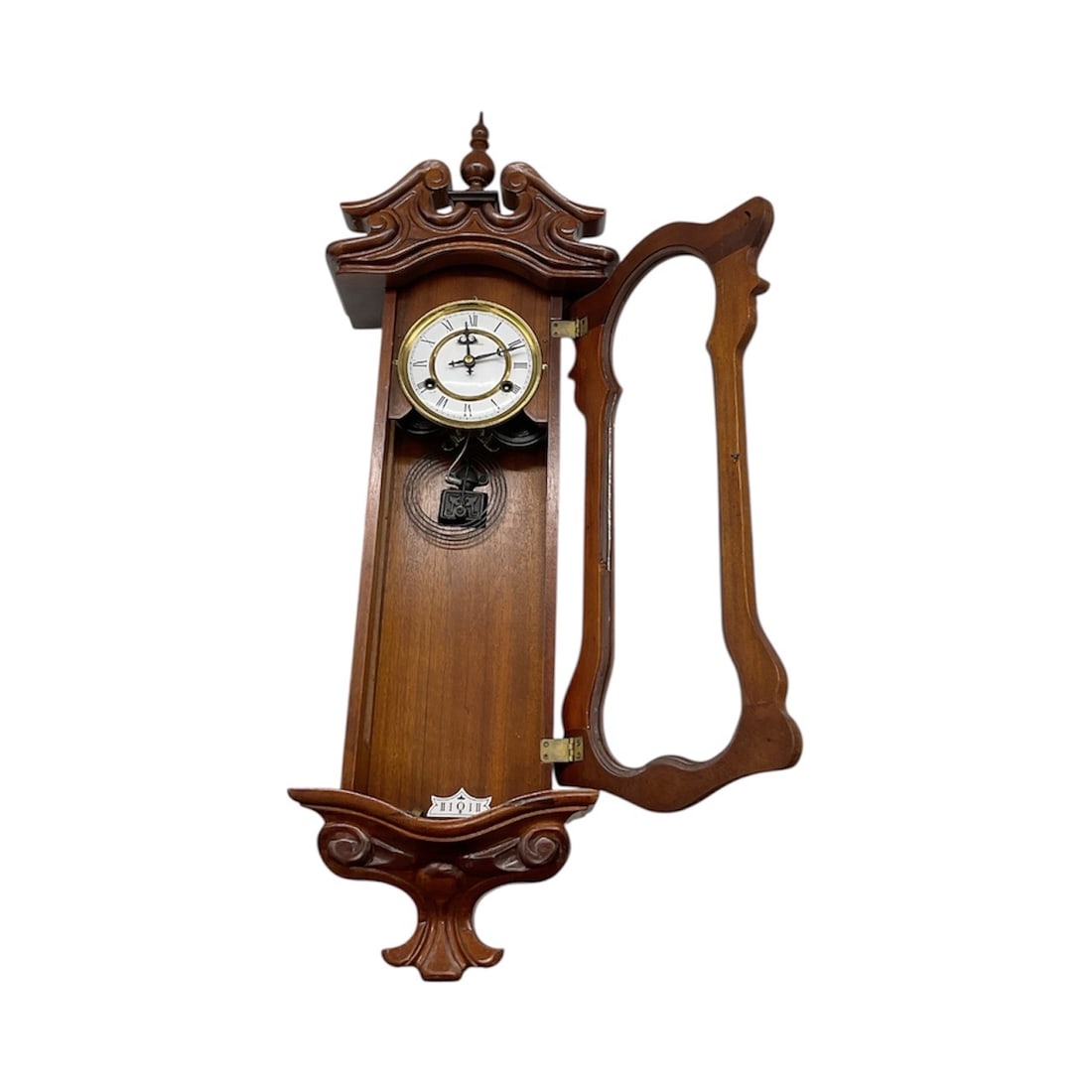 Antique Wall Clock with Key and Internal Components: Antique wall clock housed in an ornate carved wooden case with glass-front panel. Includes original key and internal clock components. Decorative architectural form with mirror backing, suitable for r