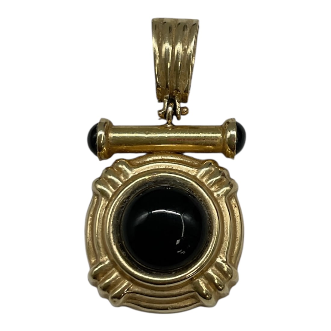 14kt Gold and Black Onyx Pendant: A distinctive 14K yellow gold pendant featuring a polished black onyx cabochon set within an ornate, sculptural frame. The central stone is surrounded by a decorative gold border with soft, fluted det