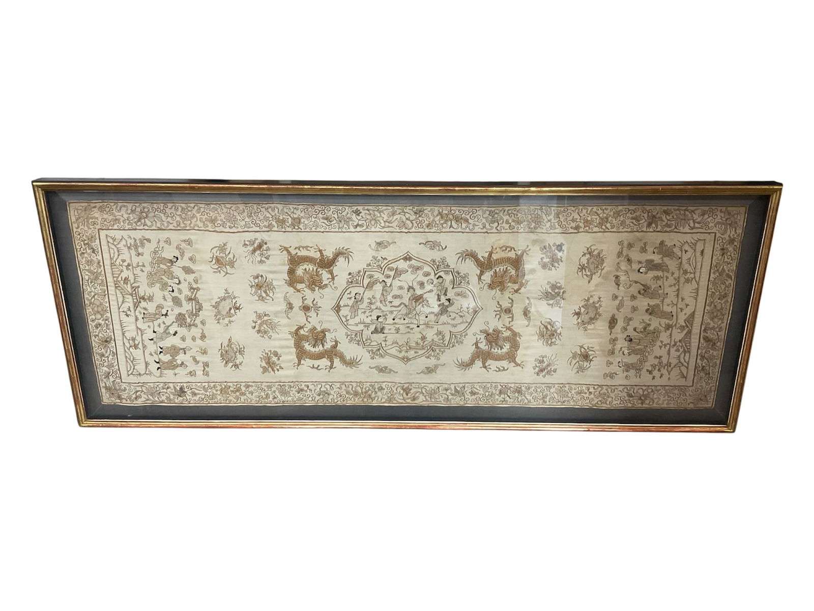 Court Scene with Five-Clawed Dragons (China, 19th Century) Silk Embroidery on Silk: This large horizontal silk panel from the late Qing Dynasty features an intricate narrative scene executed in polychrome silk and metallic-wrapped gold threads. The central composition depicts a livel