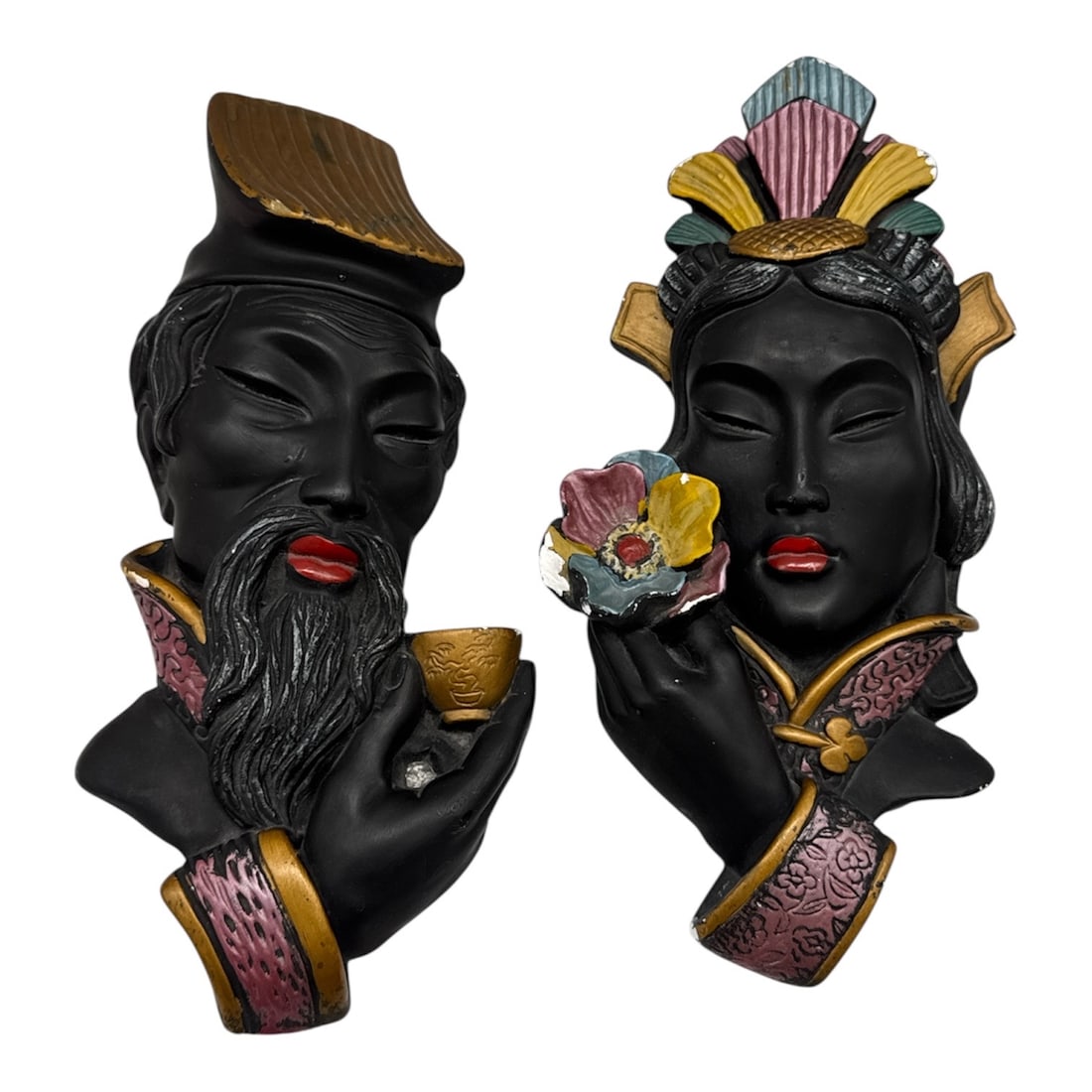 Vintage Pair of Chalkware Asian-Inspired Wall Plaques Male and Female Figures: Unique vintage pair of chalkware wall plaques depicting an Asian-inspired male and female portrait set. Each sculptural wall piece features expressive facial detailing with matte black finish and colo