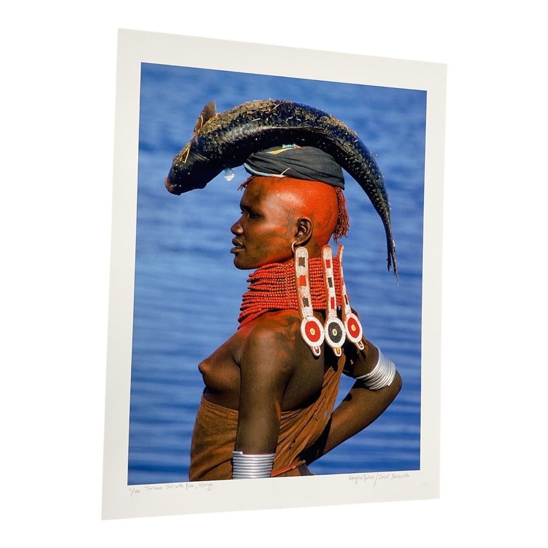 "Samburu Warrior, Kenya" by Carol Beckwith (USA, B.1945) and Angela Fisher (Australia, B.1947): This color photograph captures a ceremonial portrait of a Samburu warrior in Kenya. Known as "The Butterfly People" for their vibrant adornments, the Samburu utilize intricate beadwork and o