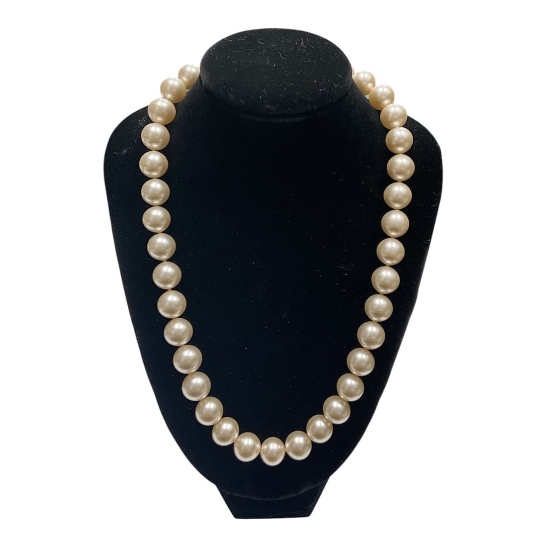 Strand of 11mm Majorca Pearls with Certificate of Warranty: A classic strand of large 11mm Majorca pearls, known for their uniform shape, smooth surface, and rich, lustrous finish. These pearls exhibit a soft, creamy tone with consistent sizing throughout the