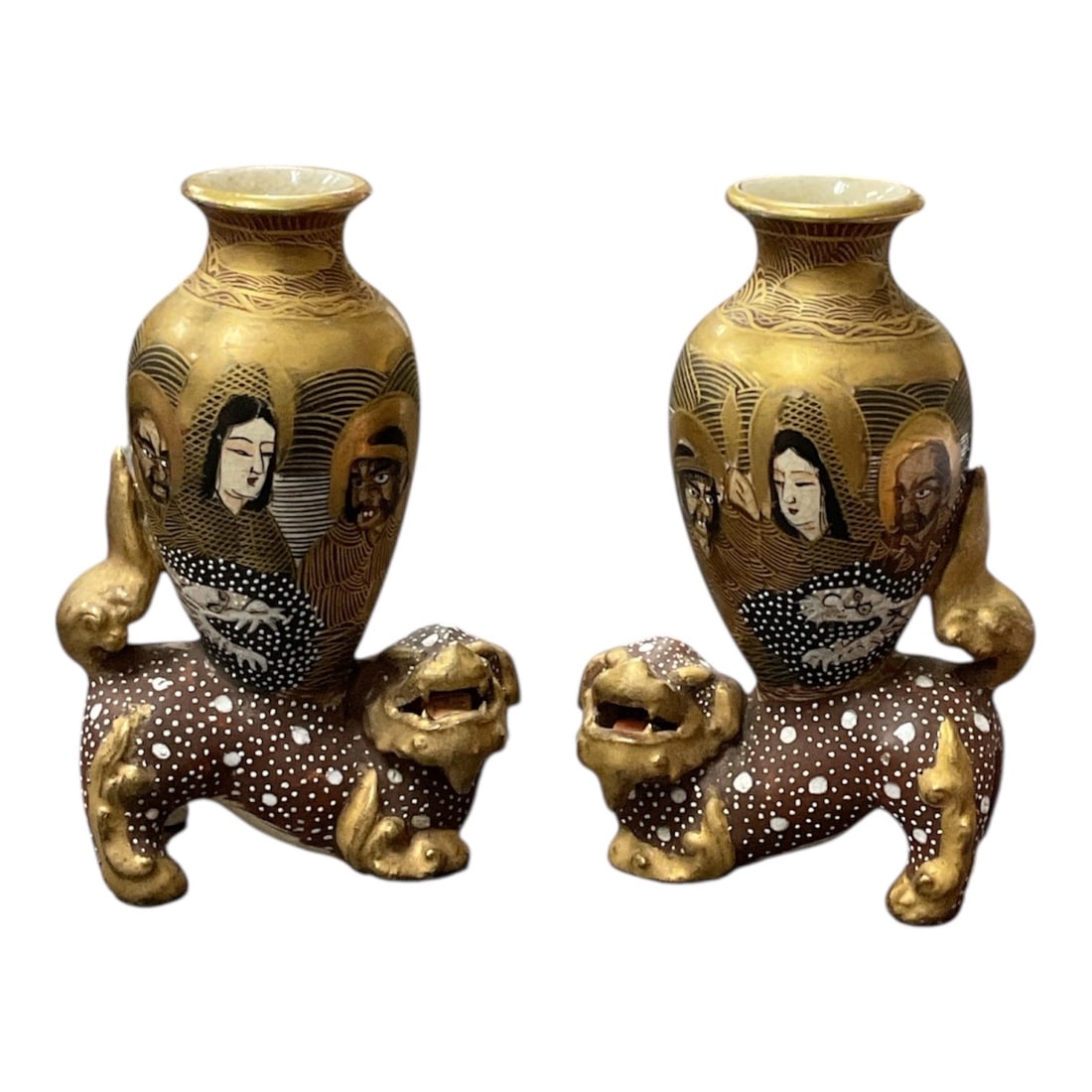"Pair of Satsuma Vases on Shi-Shi Bases" (Japan, 19th Century) Gilt and Enameled Pottery: This pair of Japanese Satsuma earthenware vases is designed with an integrated base formed by reclining Shi-Shi (Guardian Lions). The vases feature a rich gold ground decorated with finely painted Imm
