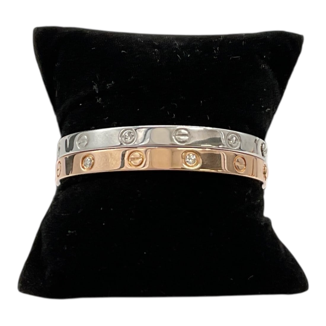 Two 18K Gold Diamond Screw Motif Bangle Bracelets White and Rose Gold: Stylish pair of 18K gold bangle bracelets featuring the iconic screw motif design, one in white gold and the other in rose gold. Each bracelet is accented with bezel-set diamonds interspersed between