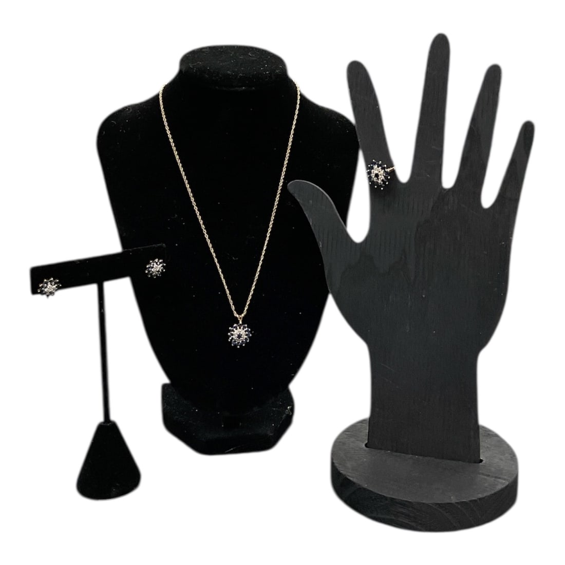 Vintage Sapphire and Diamond Cluster Jewelry Set (ring, chain with pendant, pair of earrings.): This is a coordinated fine jewelry set consisting of a ring, stud earrings, and a necklace. Each piece features a central cluster of diamonds surrounded by a halo of deep blue sapphires, set in y