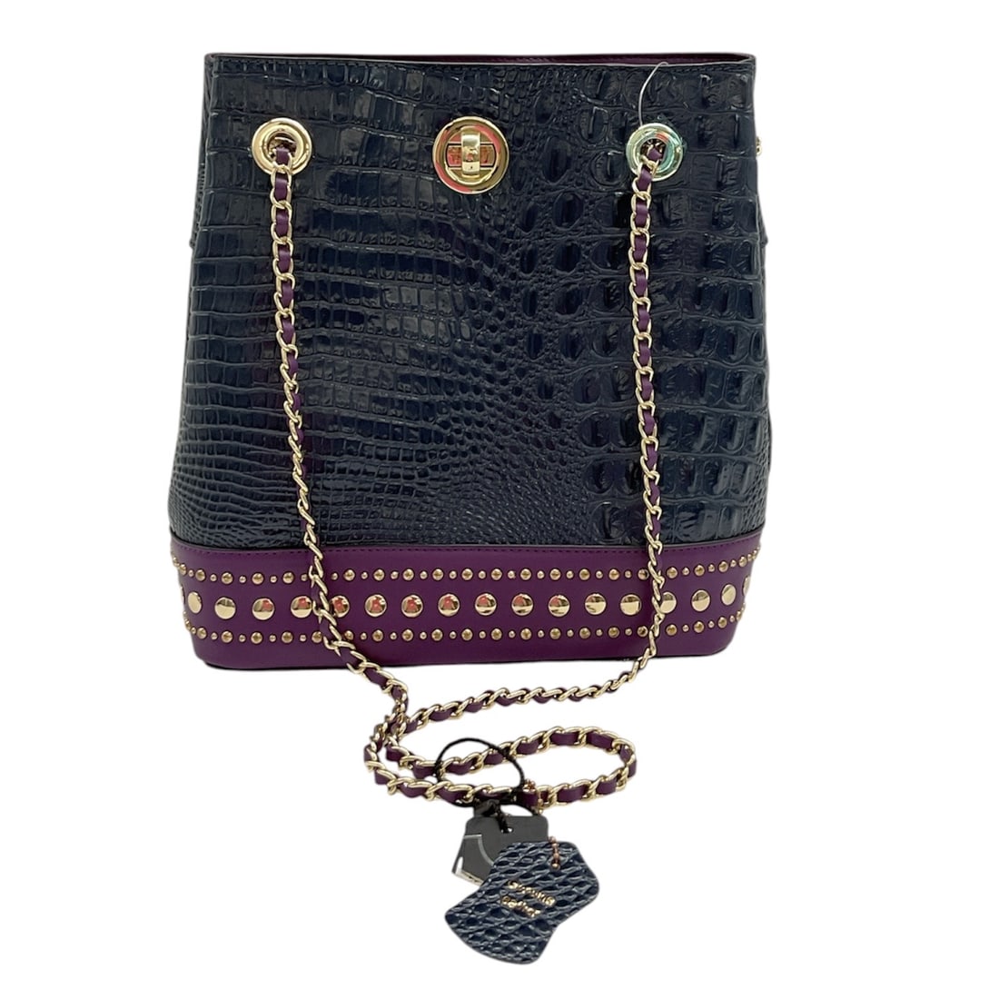 Macy Croco Bucket Bag from M.C. Handbags: Black croc-embossed leather bucket-style shoulder bag by M.C. Handbags for Macy’s, featuring rich purple leather trim and base with gold-tone stud embellishments. Designed with dual chain-link s